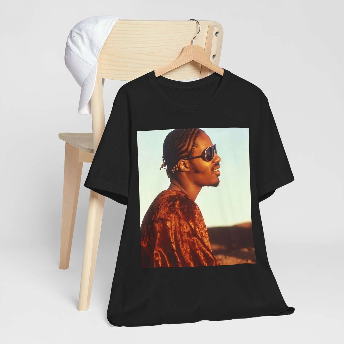 A black graphic t-shirt featuring a graphic of Stevie Wonder as an iconic style pop innovator.