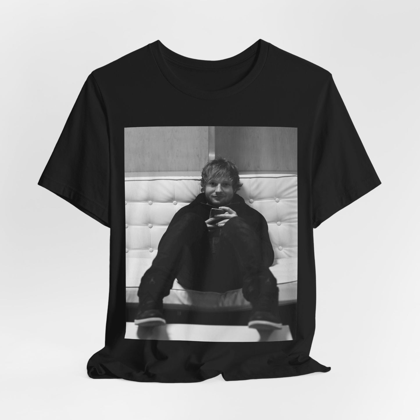 A black graphic t-shirt featuring a bold black and white graphic of Ed Sheeran.