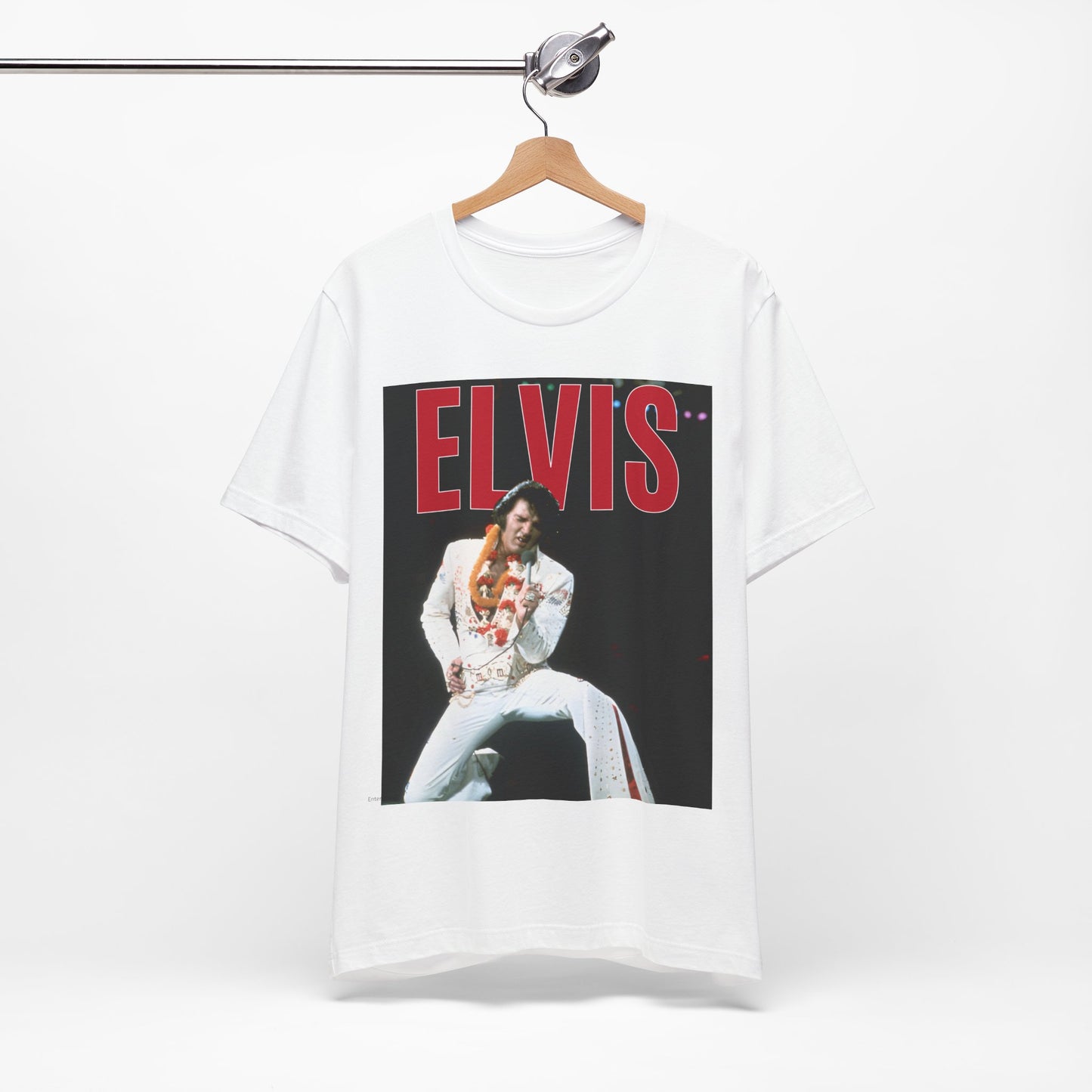 A black graphic t-shirt featuring a glamorous graphic or photo of Elvis Presley on a Las Vegas stage.