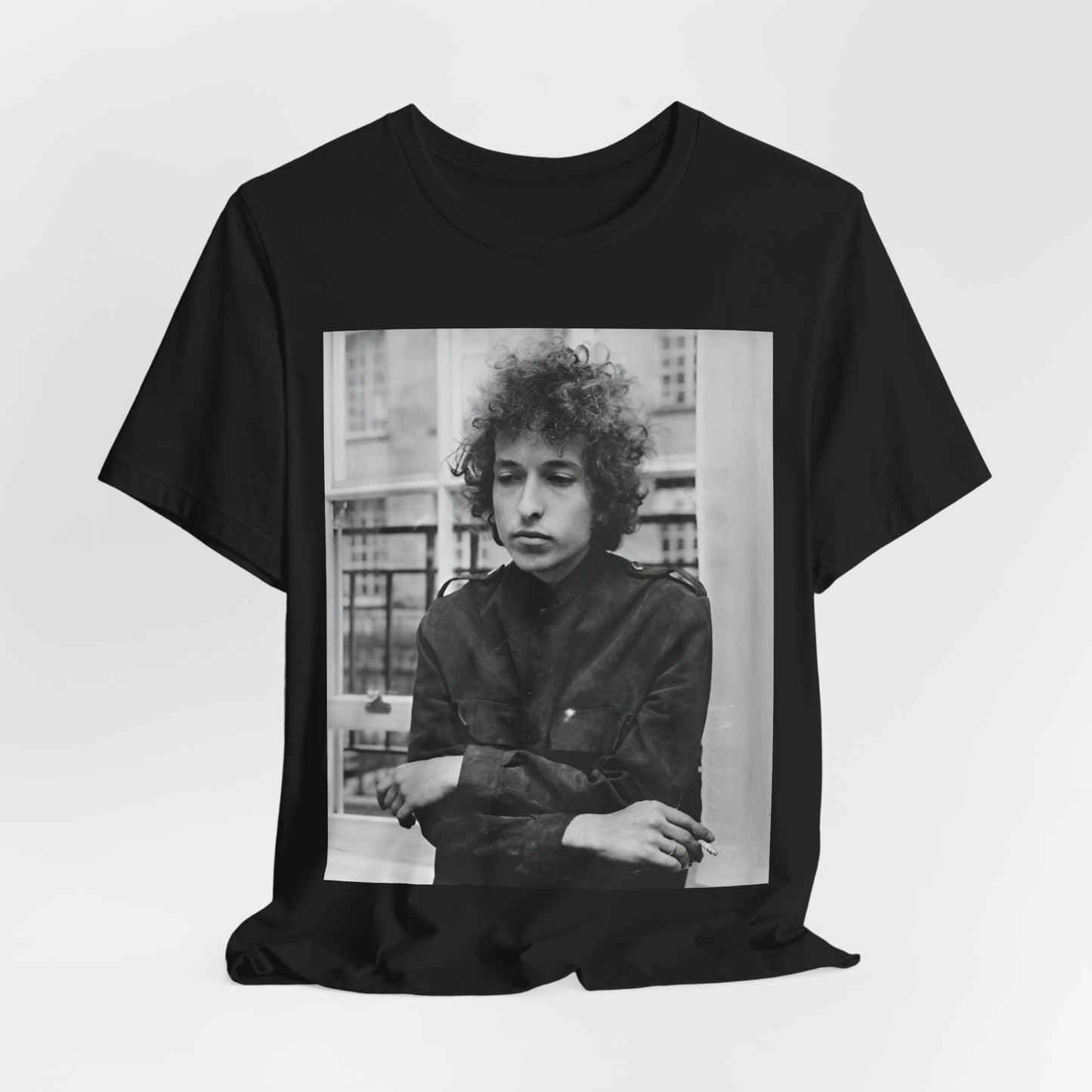 A black graphic t-shirt featuring a black and white graphic of Bob Dylan from the folk revival era.