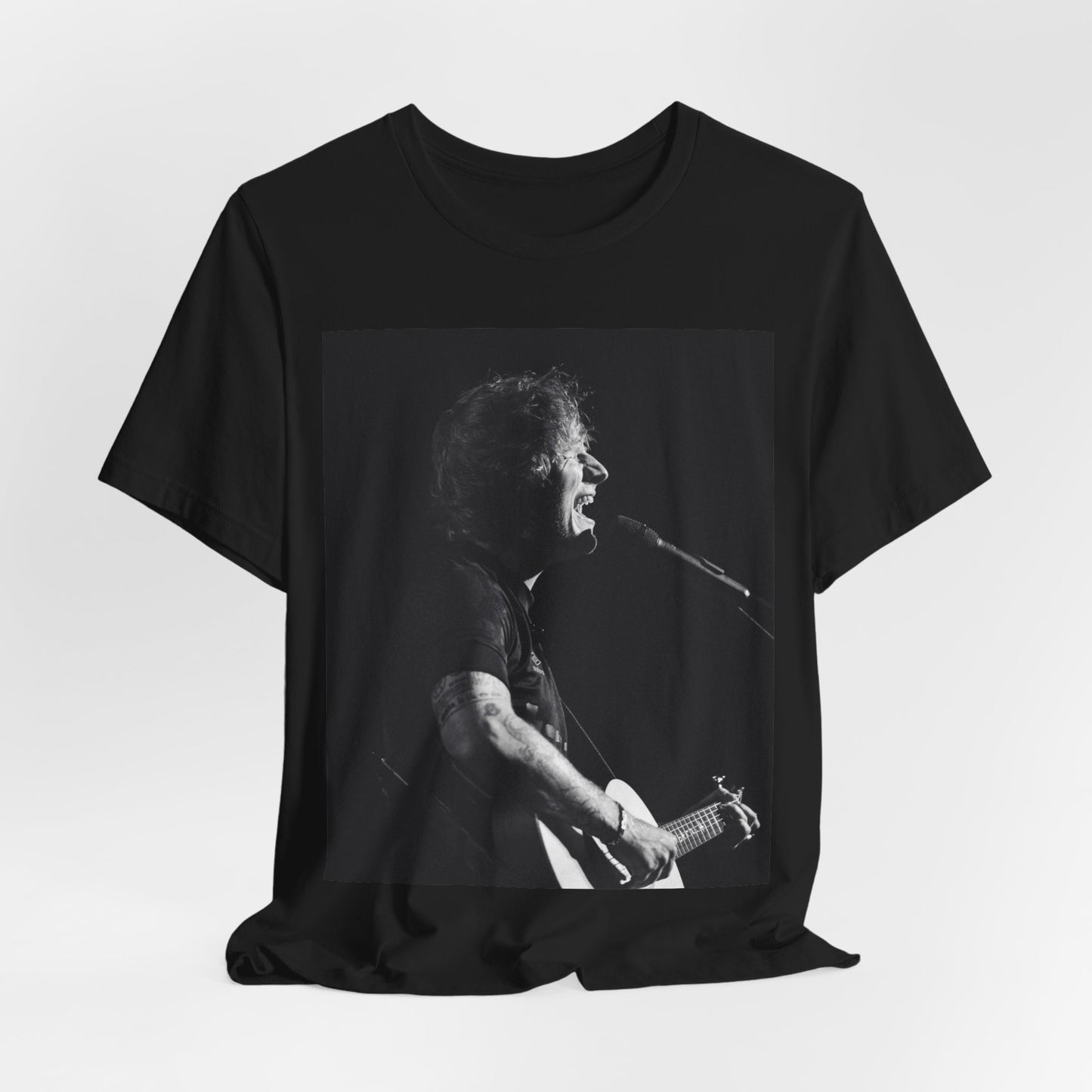 A black graphic t-shirt featuring a graphic related to Ed Sheeran's stadium tour.