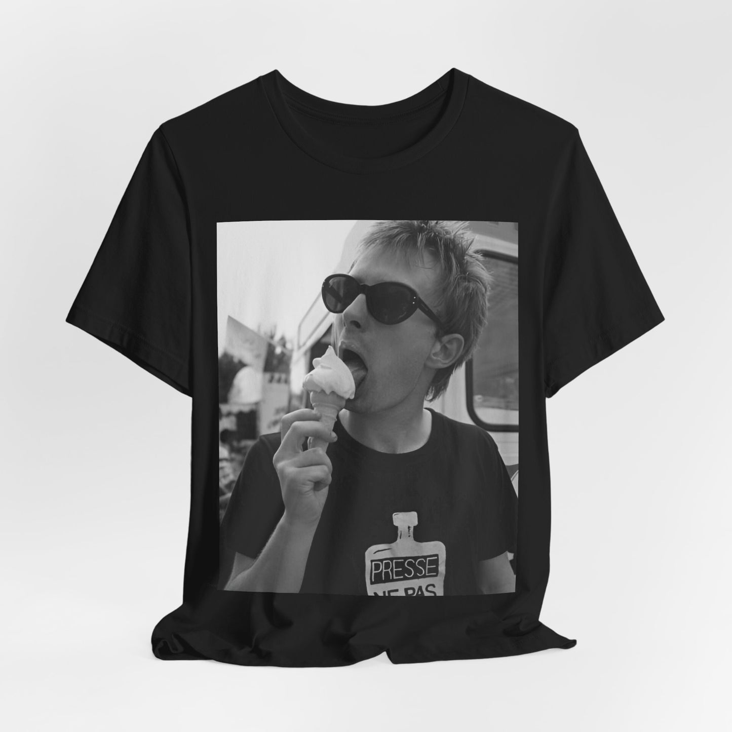 A black graphic t-shirt featuring a graphic of Thom Yorke from Radiohead with an ice cream cone.