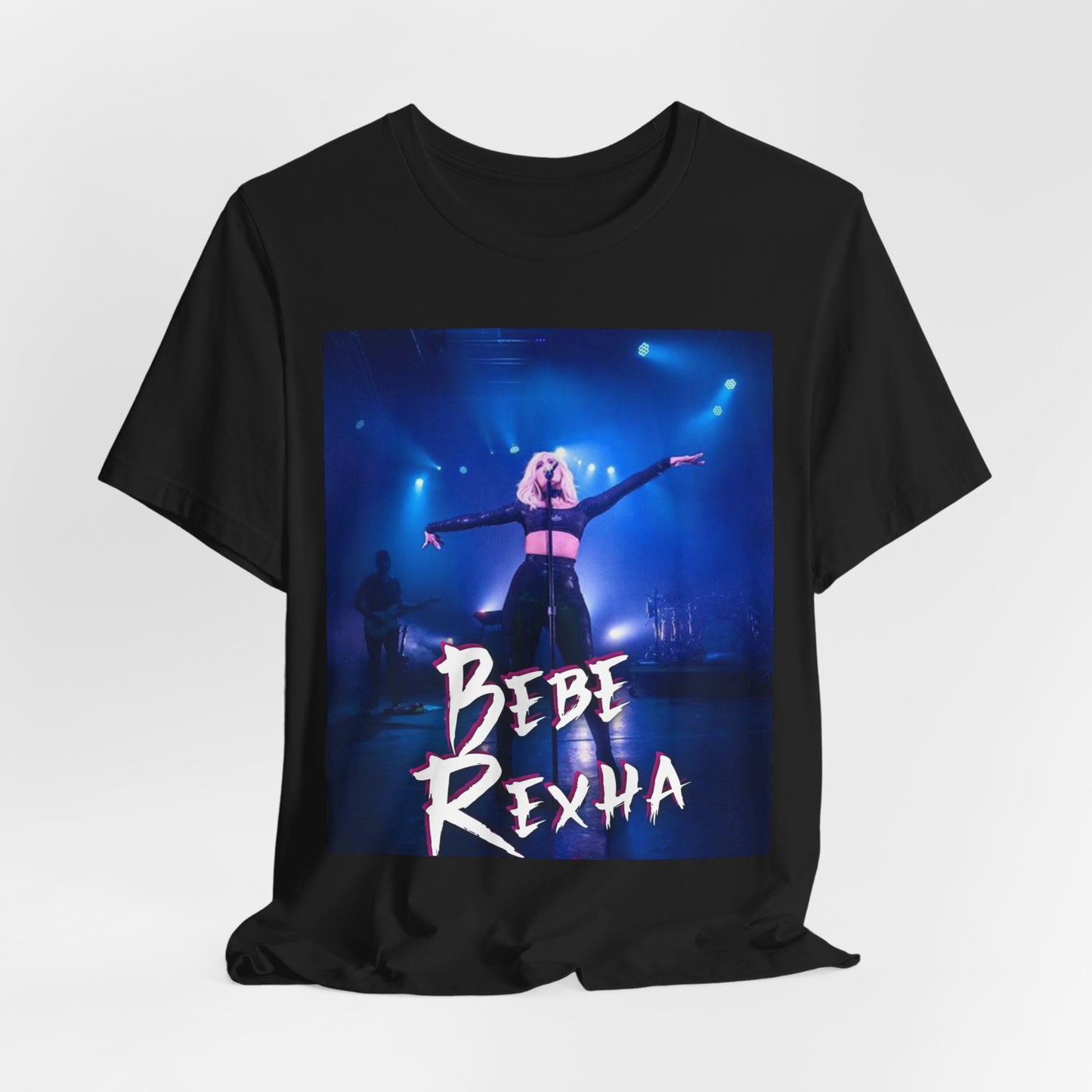 A black graphic t-shirt featuring a dynamic graphic or photo of Bebe Rexha performing live on stage.