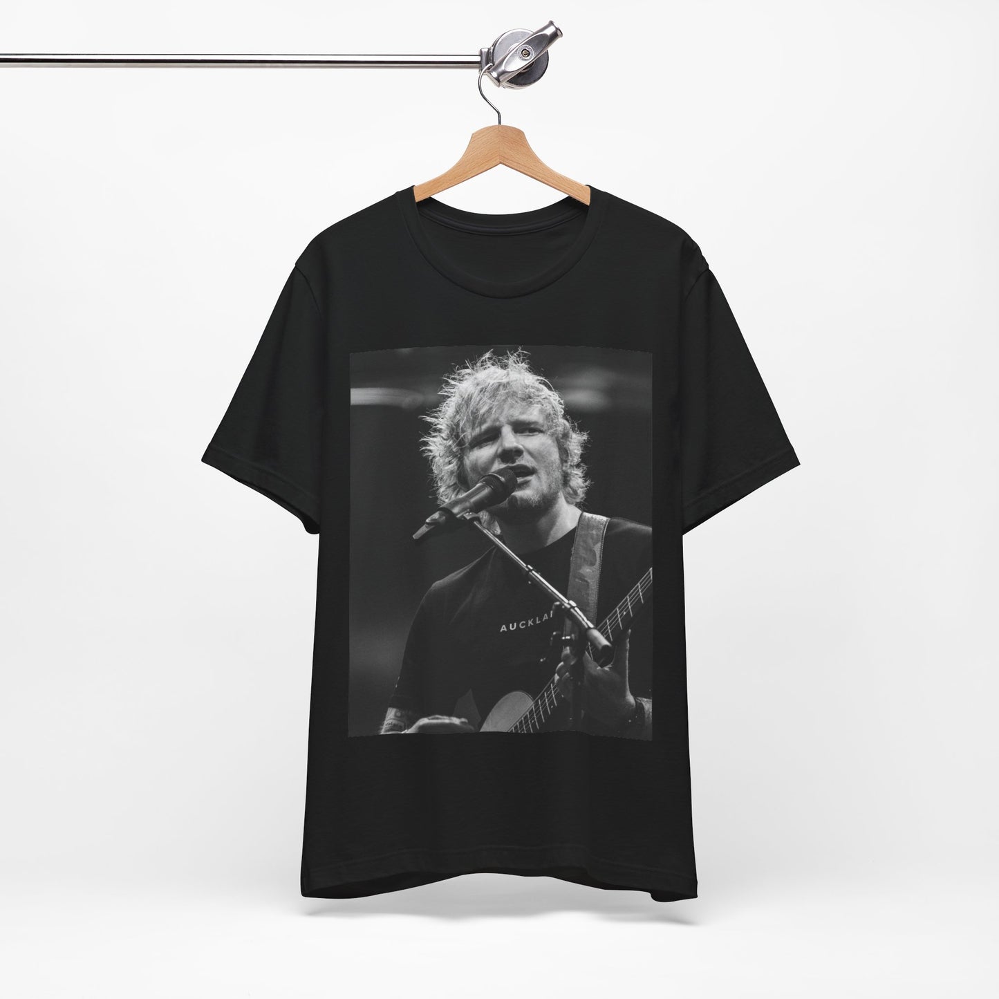 A black graphic t-shirt featuring a black and white photo of Ed Sheeran performing live.