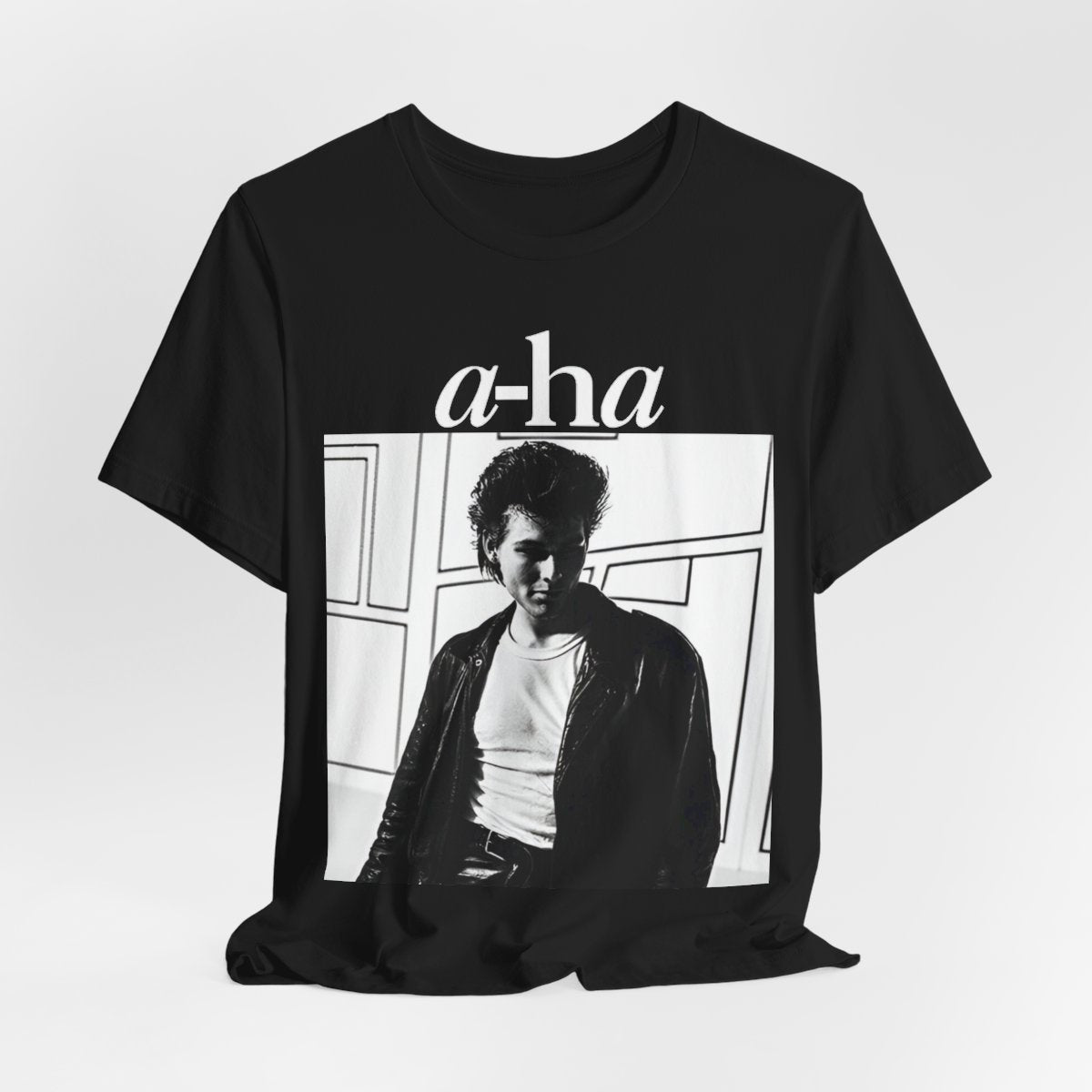 A black graphic t-shirt featuring a stylized pop art graphic inspired by A-HA's "Take On Me" music video from 1985.
