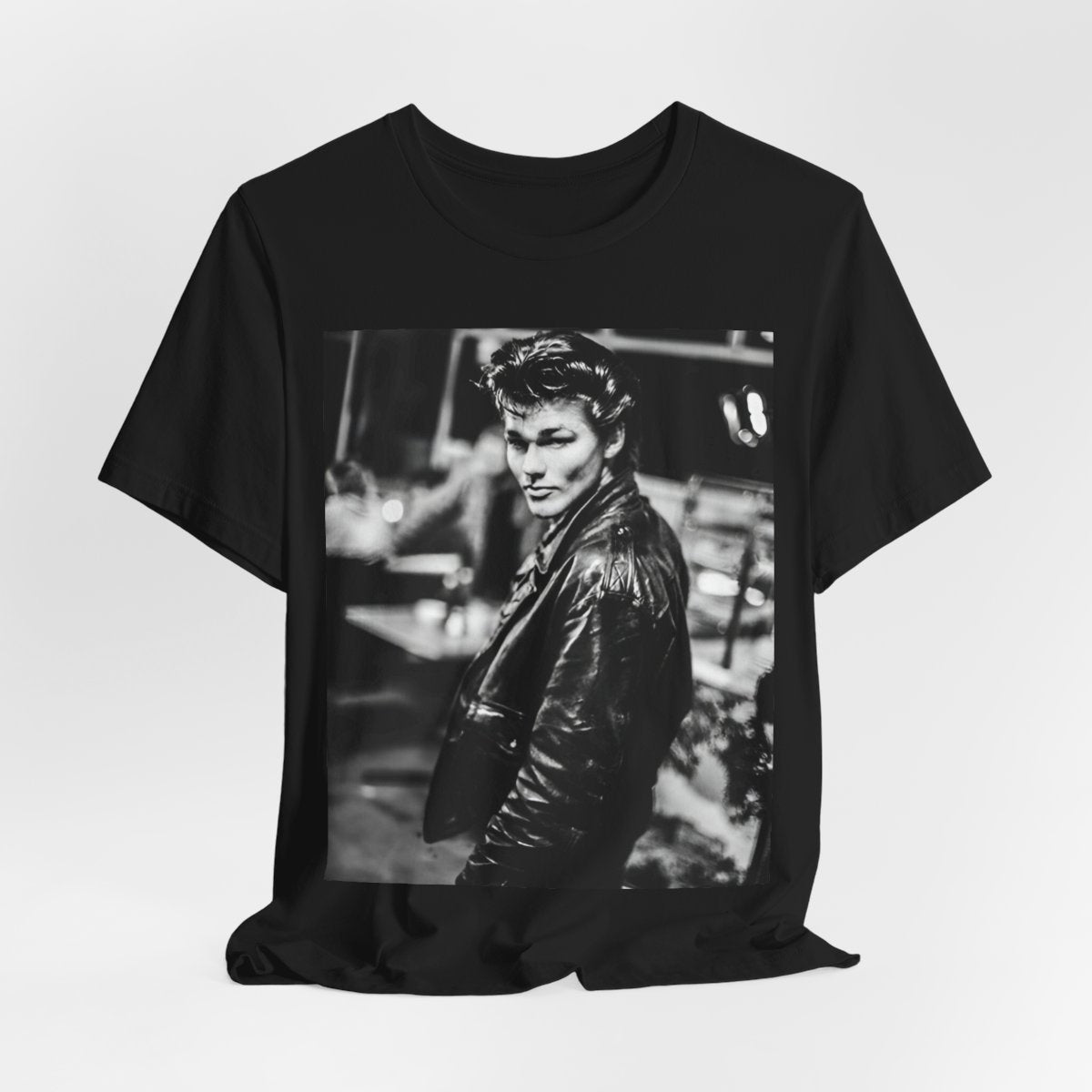 A black graphic t-shirt featuring a retro 80s tour graphic for the band A-HA, possibly showing concert elements or band members in a stylized design.