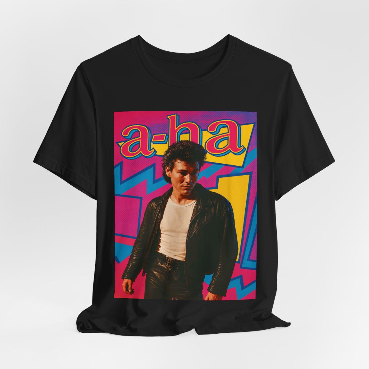 A black graphic t-shirt featuring a retro 80s pop art style illustration of the band A-HA, with vibrant colors and bold lines.
