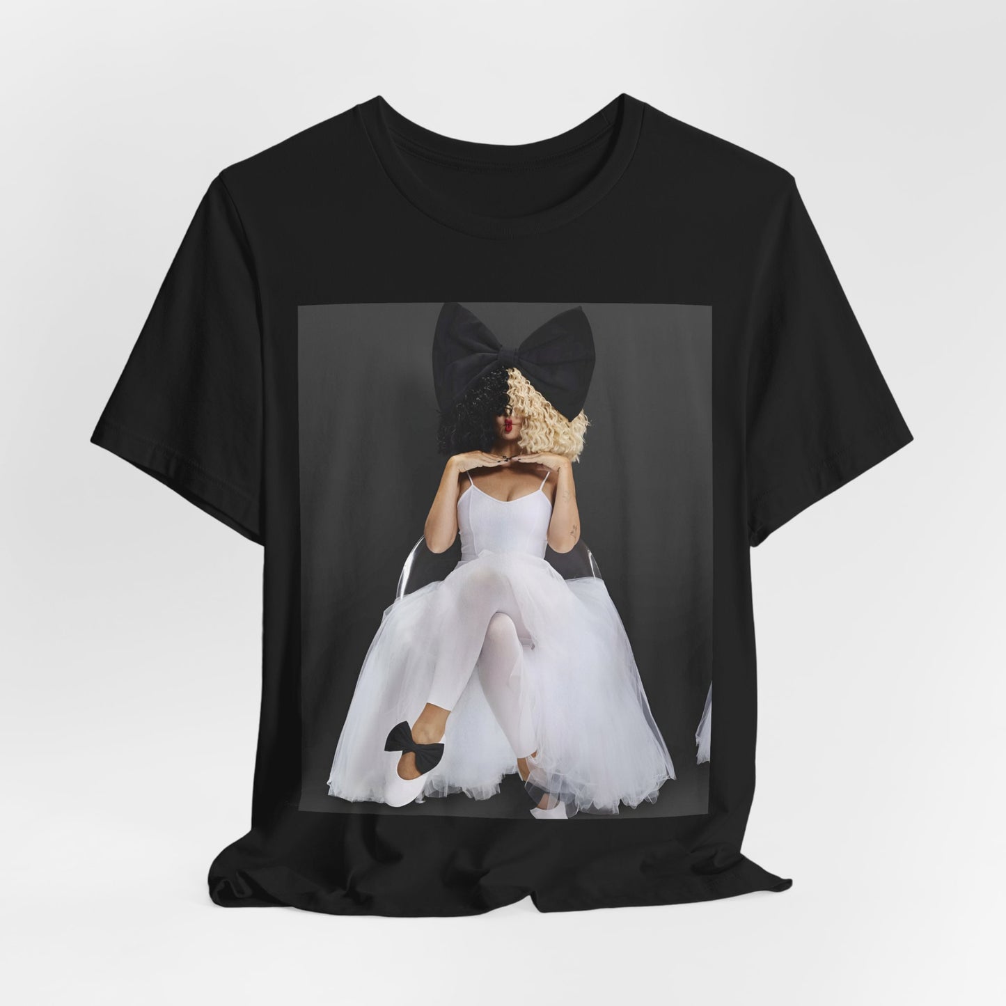 A black graphic t-shirt featuring a graphic of Sia's iconic wig style.