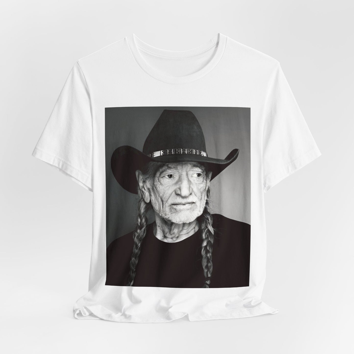 A black graphic t-shirt featuring a graphic of Willie Nelson with his iconic guitar 'Trigger'.