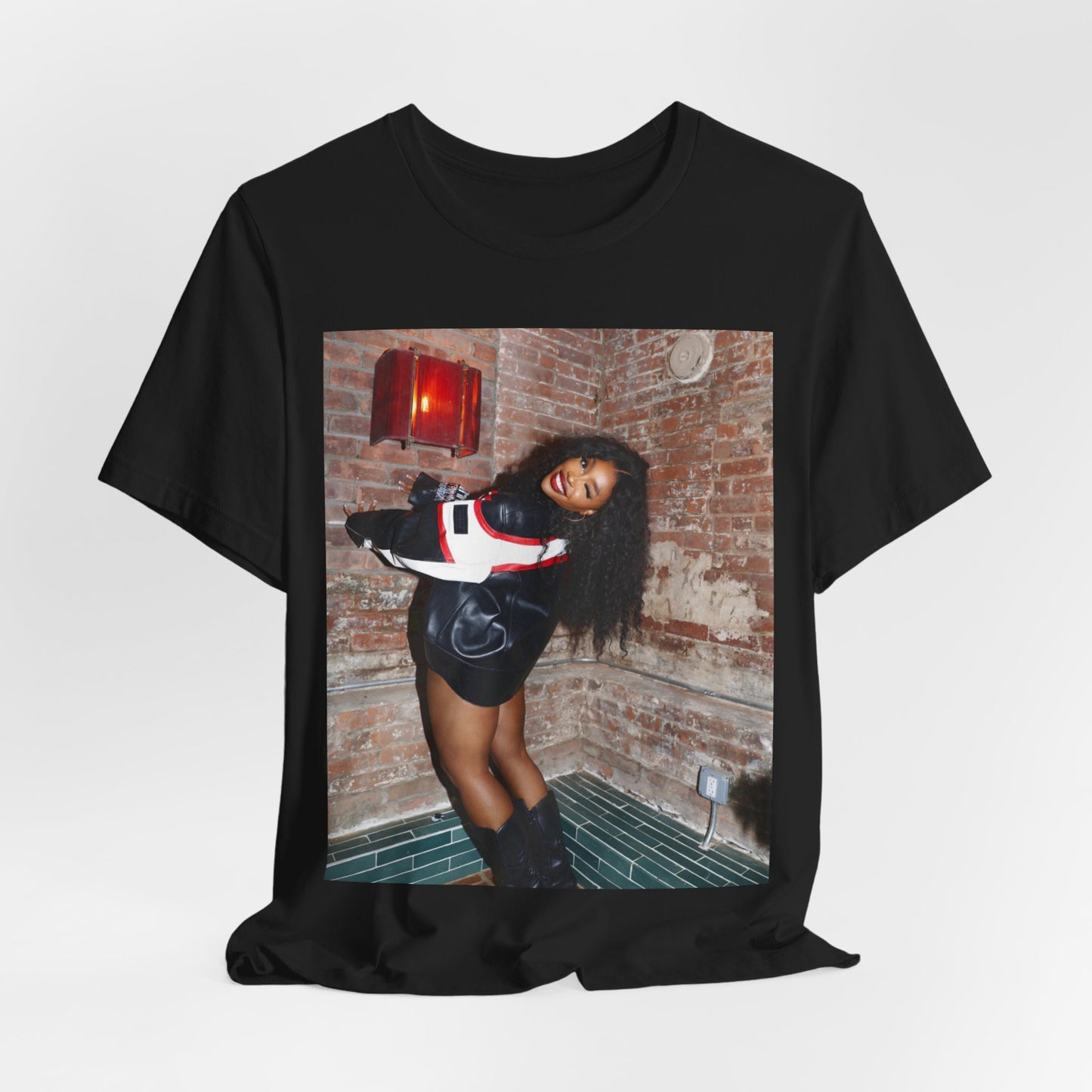 A black graphic t-shirt featuring a graphic of SZA as a TDE Queen R&B icon.