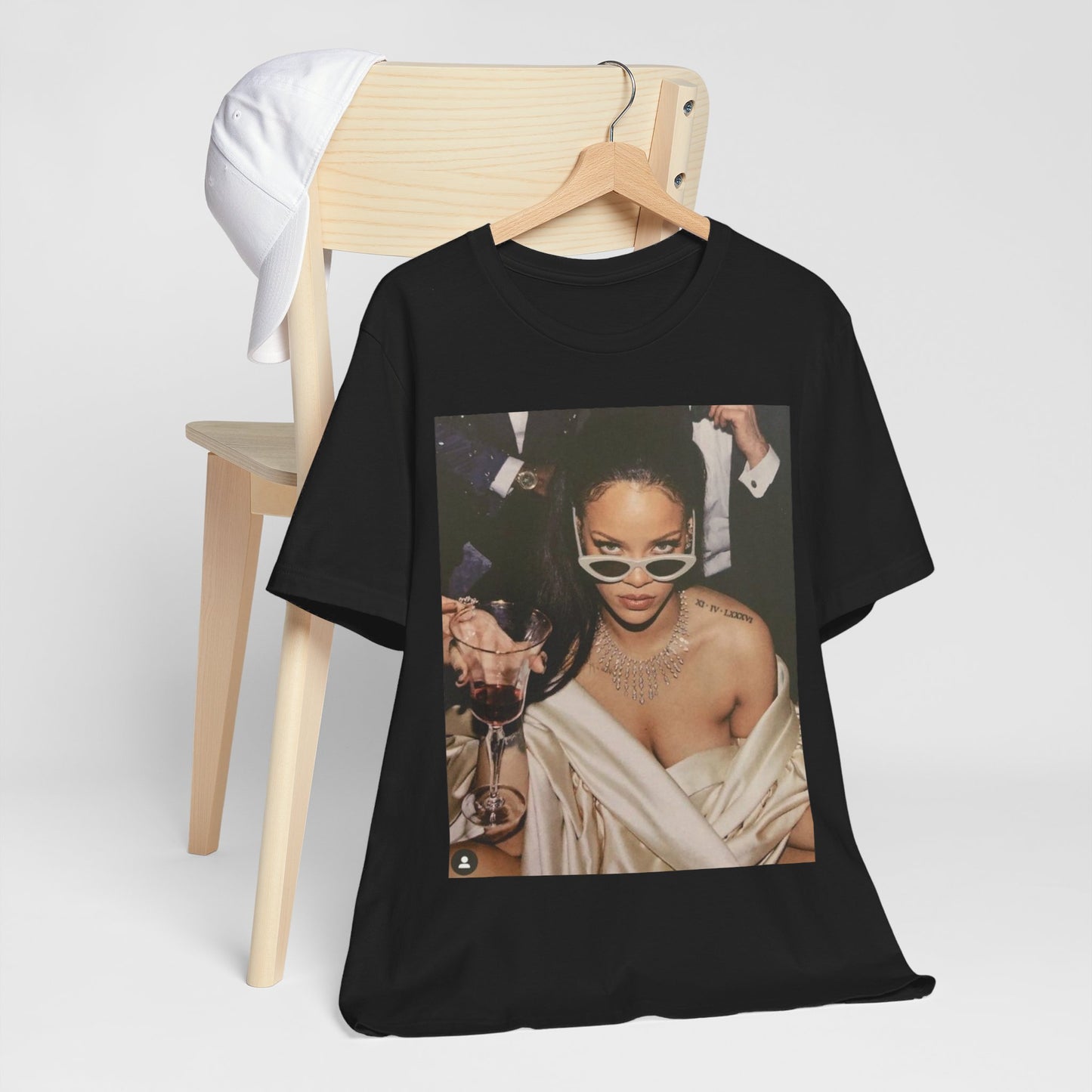 A black graphic t-shirt featuring a graphic of Rihanna as a 'Bad Gal Riri' fashion icon.