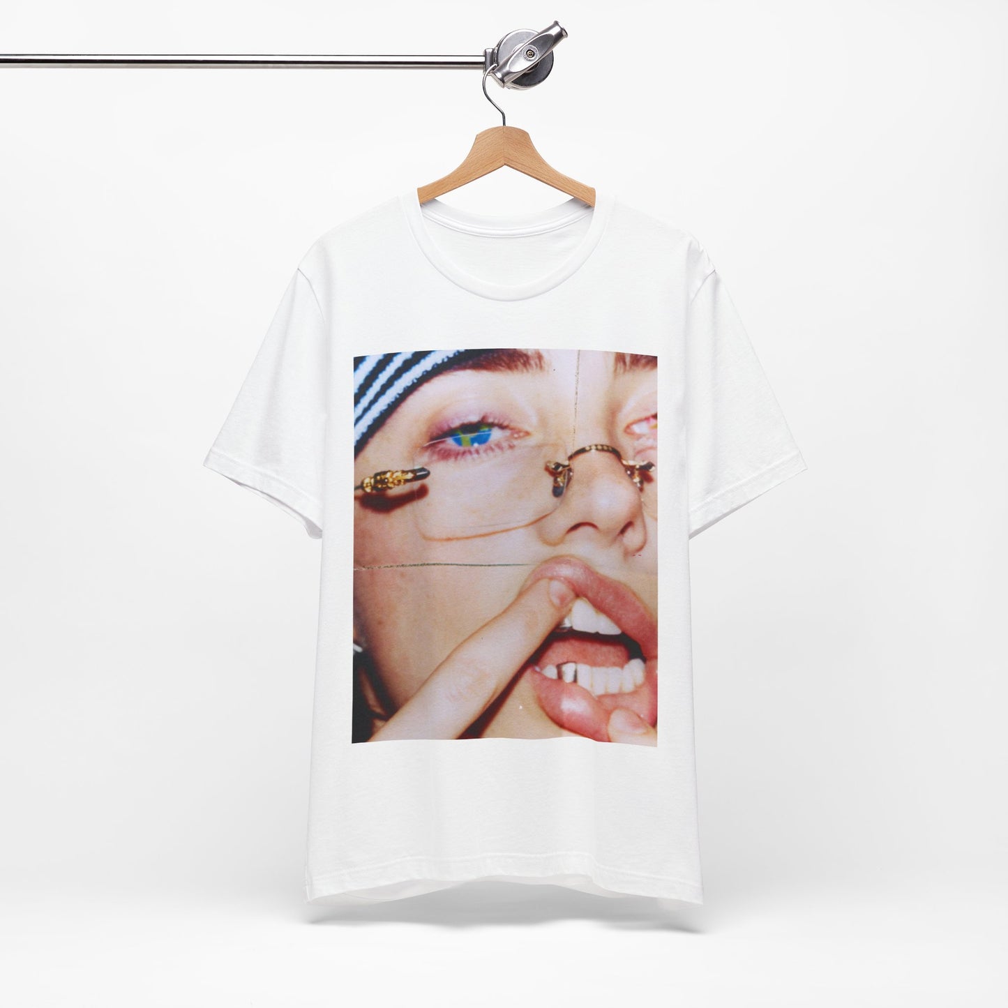 A direct, unfiltered, close-up portrait of Billie Eilish with dark hair looking straight at the camera, printed on a t-shirt.