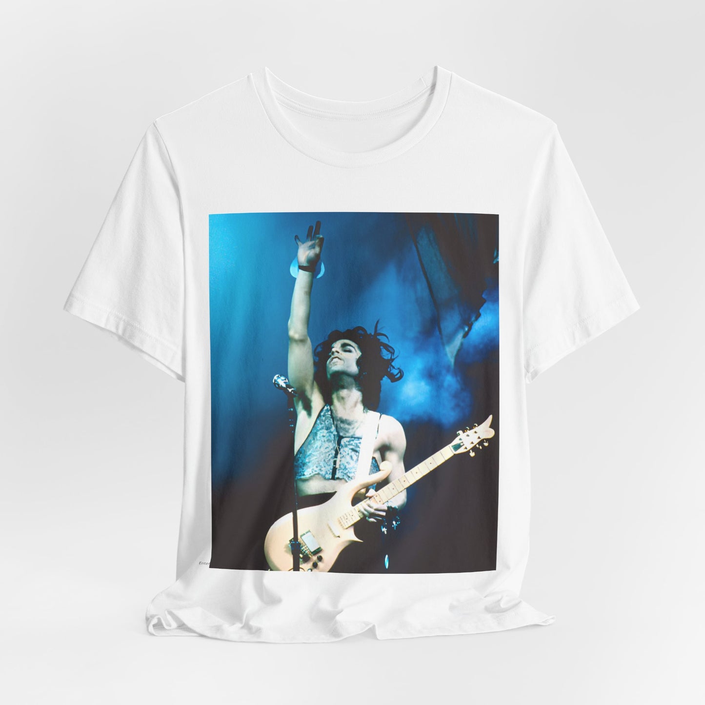A black graphic t-shirt featuring a graphic of Prince as a guitar god and virtuoso performer.