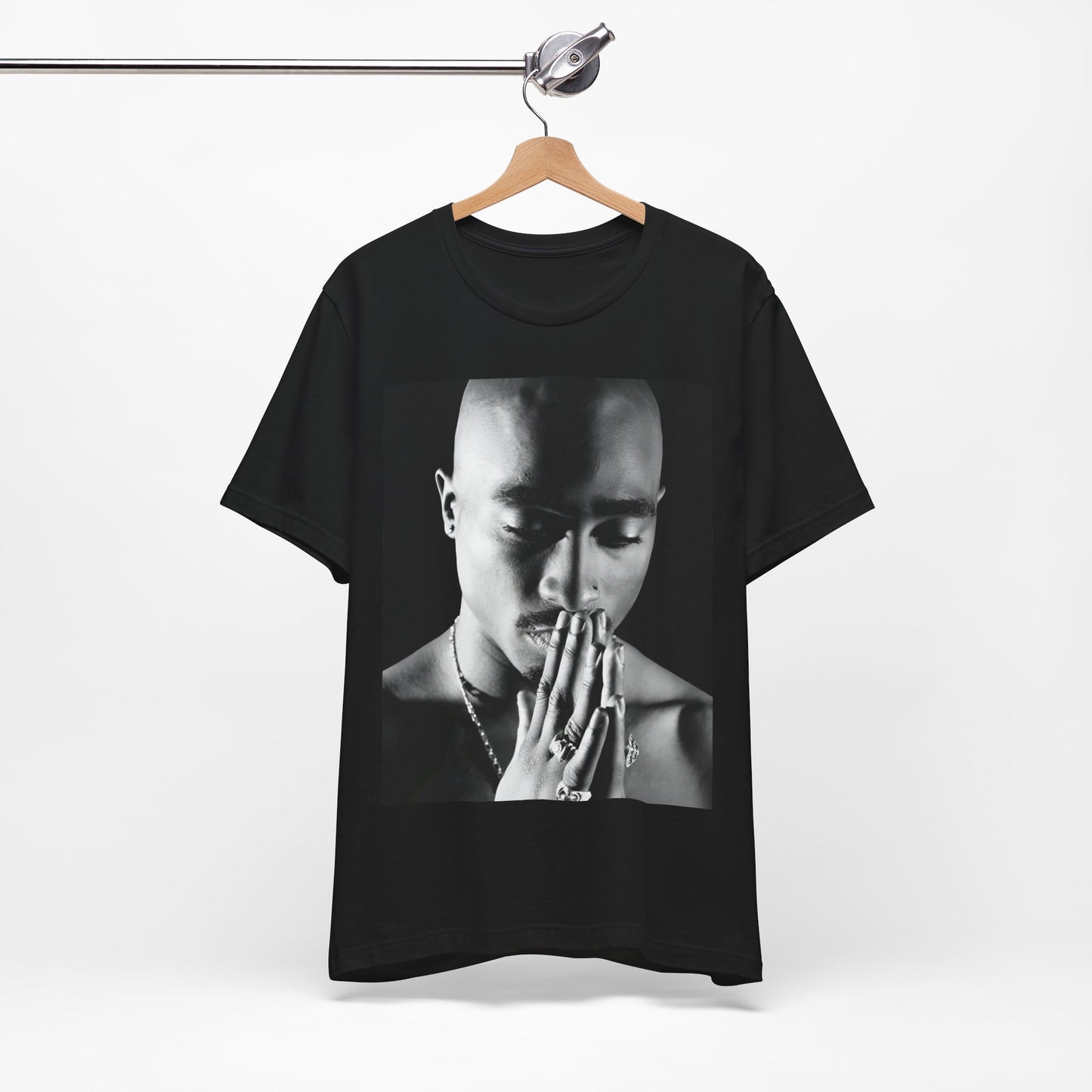 A black graphic t-shirt featuring a black and white streetwear rebel graphic of Tupac.