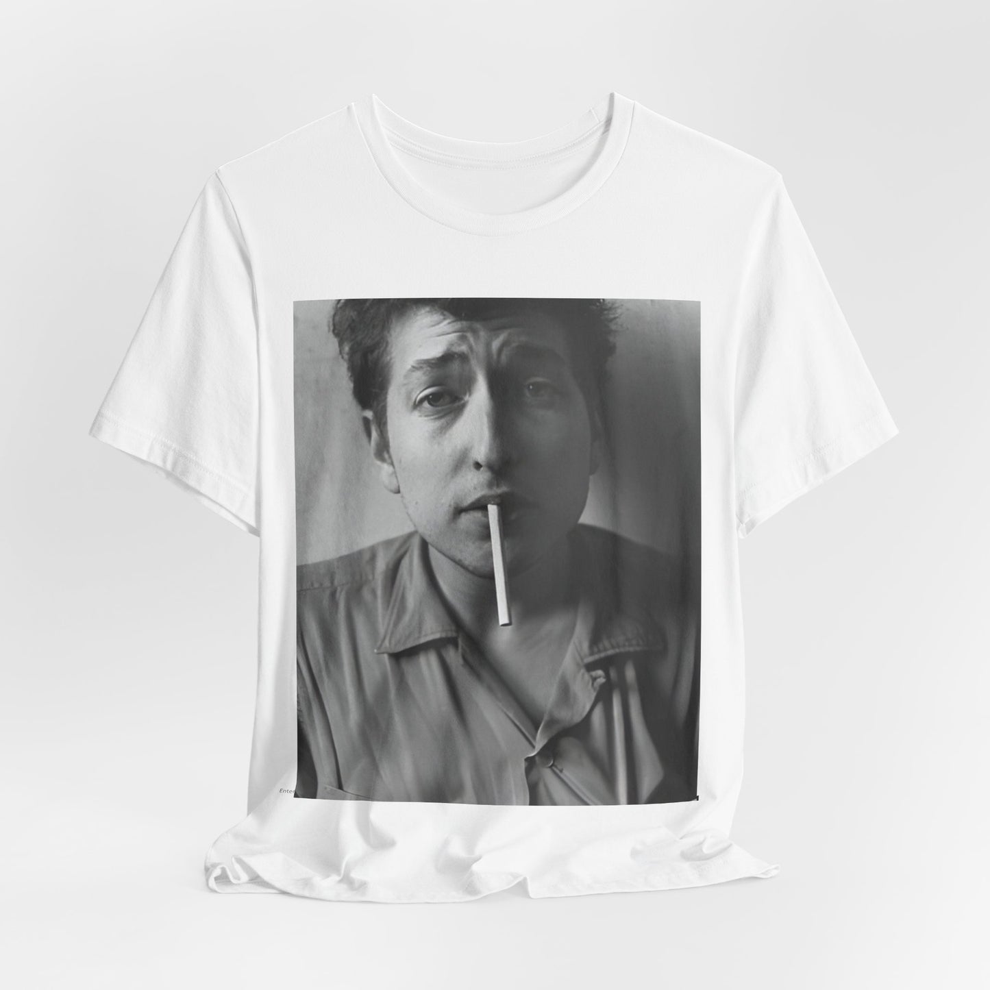 A black graphic t-shirt featuring a graphic of Bob Dylan from the 60s, depicted as a renegade folk icon.