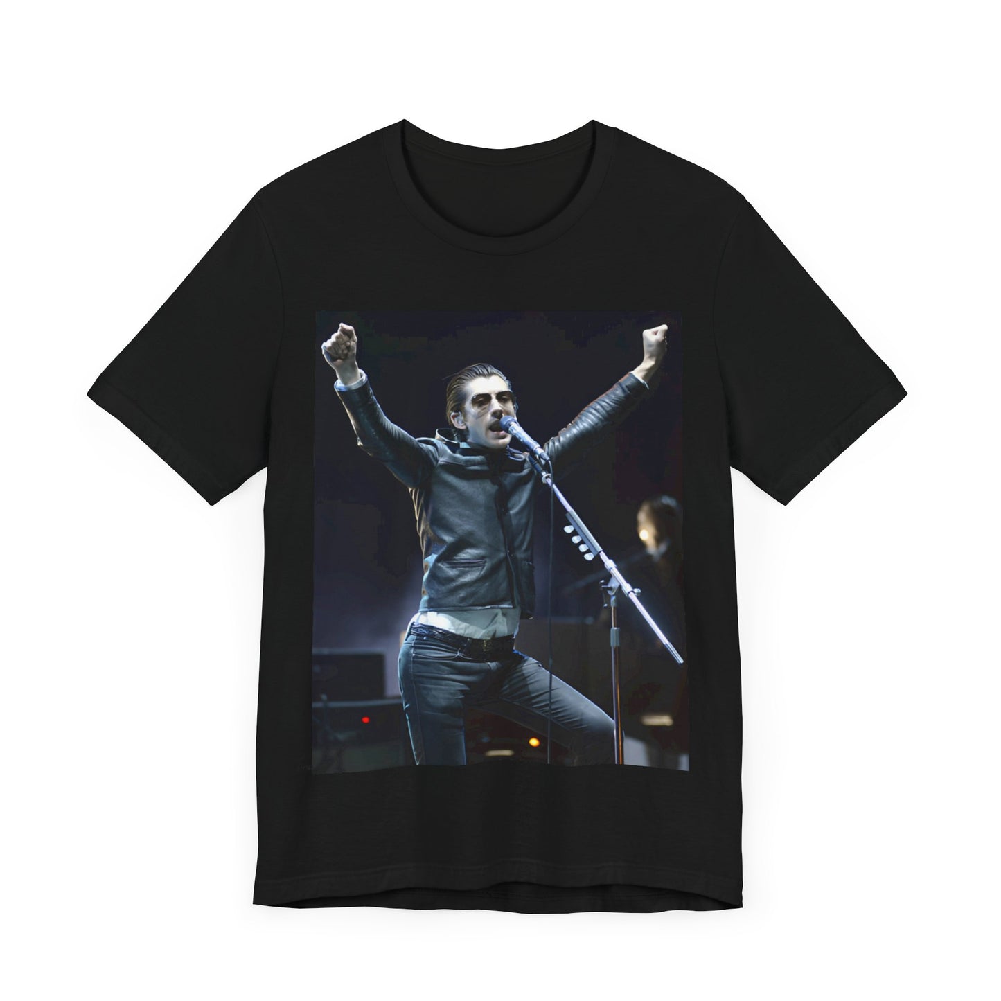 A black graphic t-shirt featuring a graphic or photo of Arctic Monkeys performing live on stage, with a Britpop aesthetic.