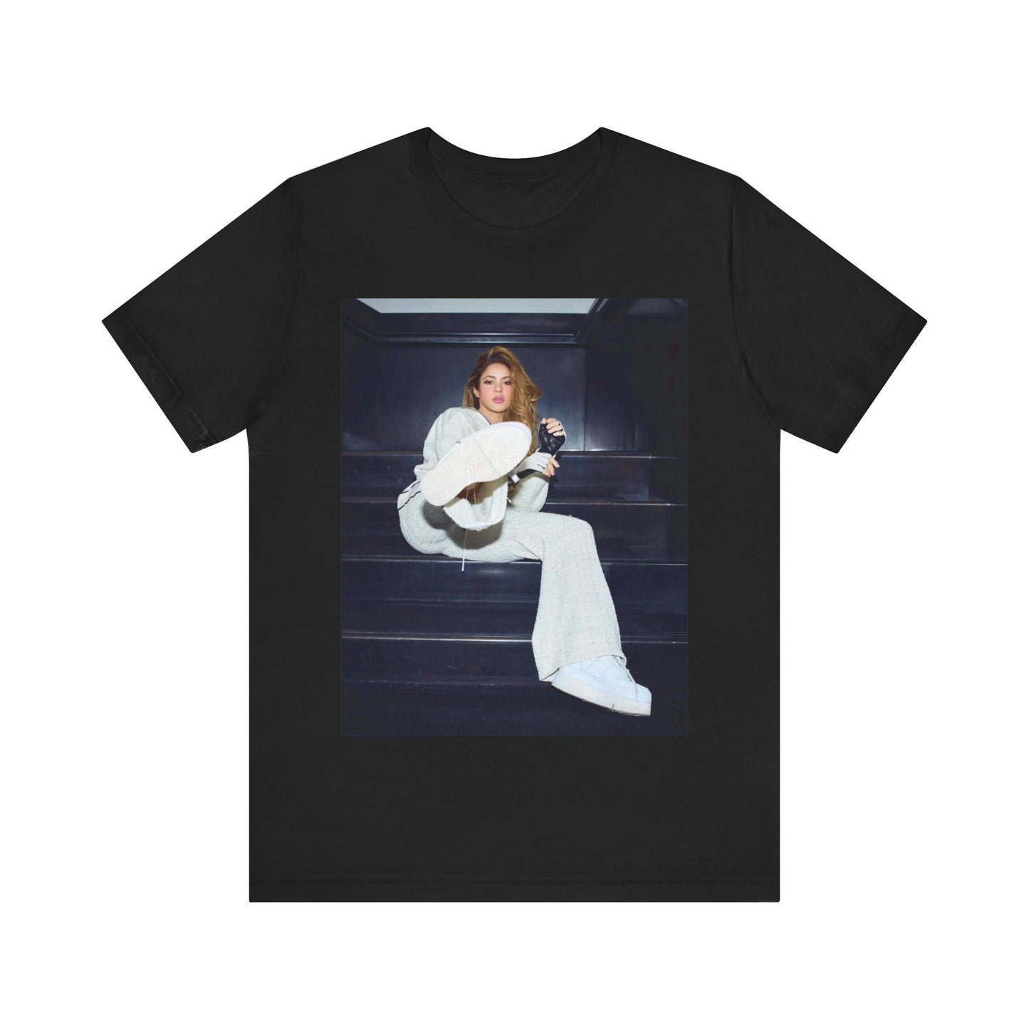 A black graphic t-shirt featuring a vintage Latin pop icon graphic of Shakira.