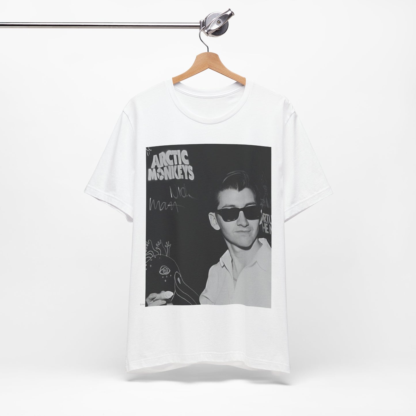 A black graphic t-shirt featuring a black and white portrait photo of Alex Turner from Arctic Monkeys, showing his signature look.