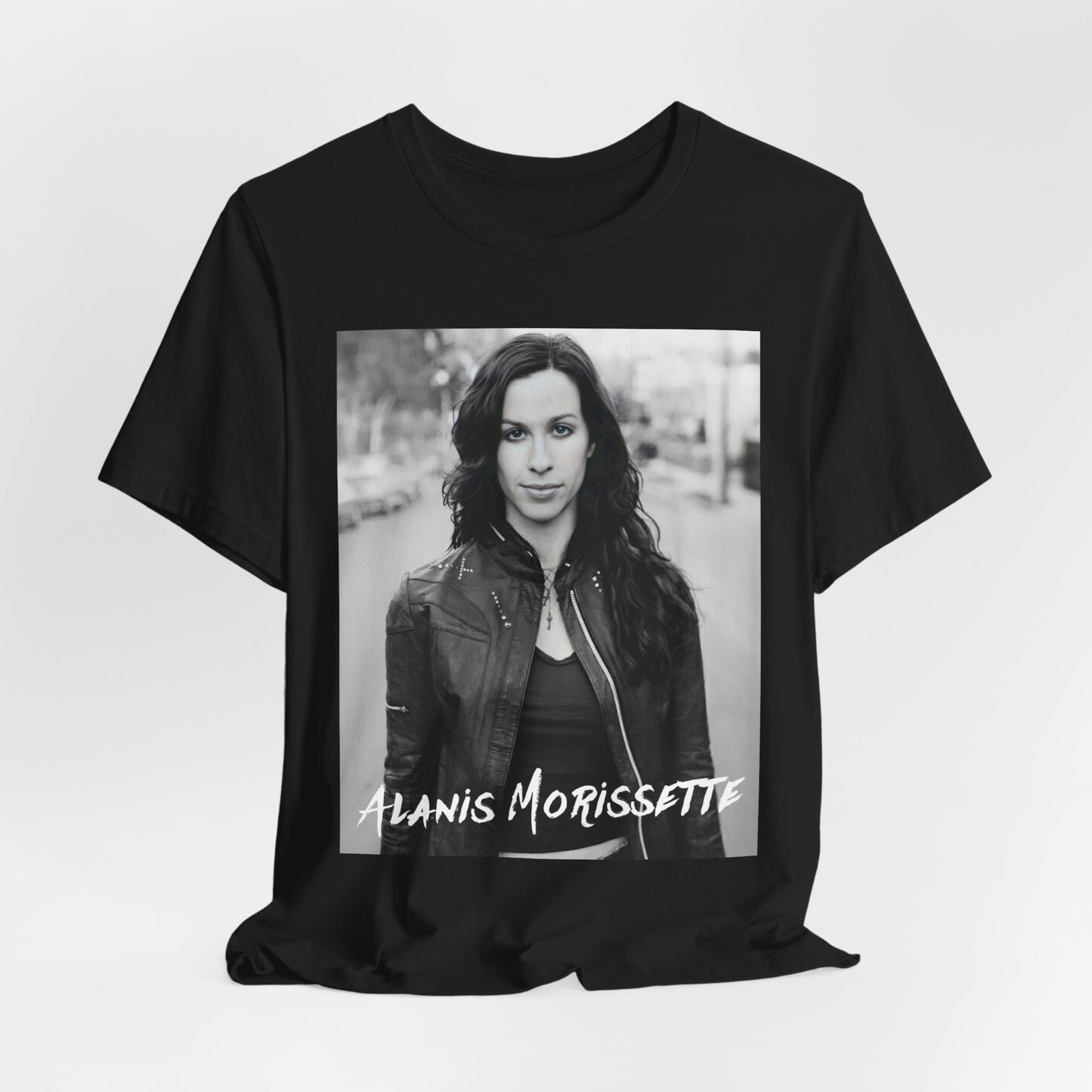 A black graphic t-shirt featuring a black and white photo of Alanis Morissette from 1998, showing her with a poised or thoughtful expression.