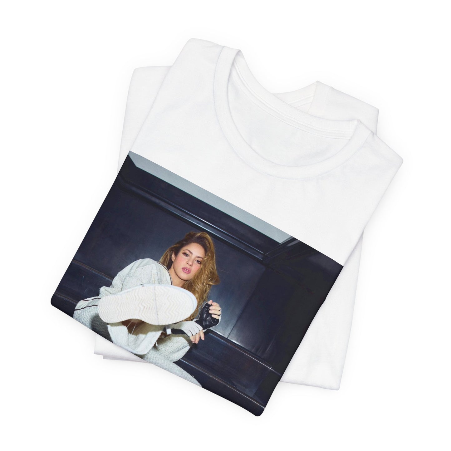 A black graphic t-shirt featuring a vintage Latin pop icon graphic of Shakira.