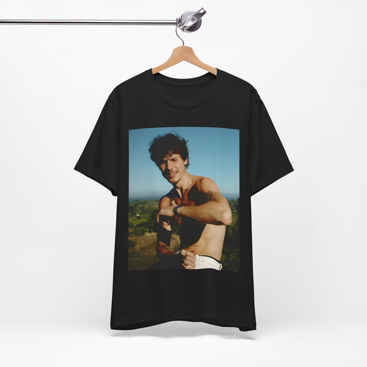 A black graphic t-shirt featuring a graphic of Shawn Mendes with a chill pop star look.