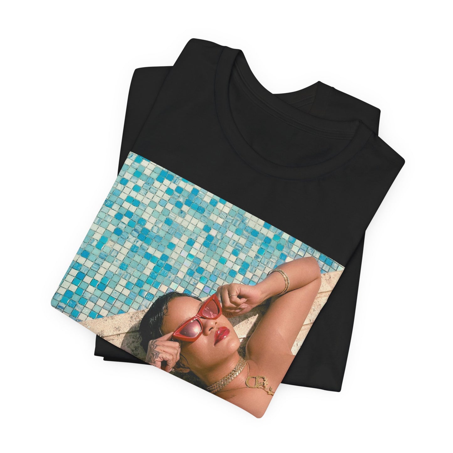 A black graphic t-shirt featuring a graphic of Rihanna in swimwear as a pop star queen.