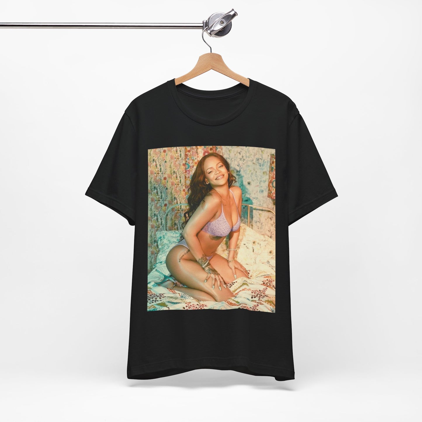 A black graphic t-shirt featuring a graphic of Rihanna with a beauty aesthetic.