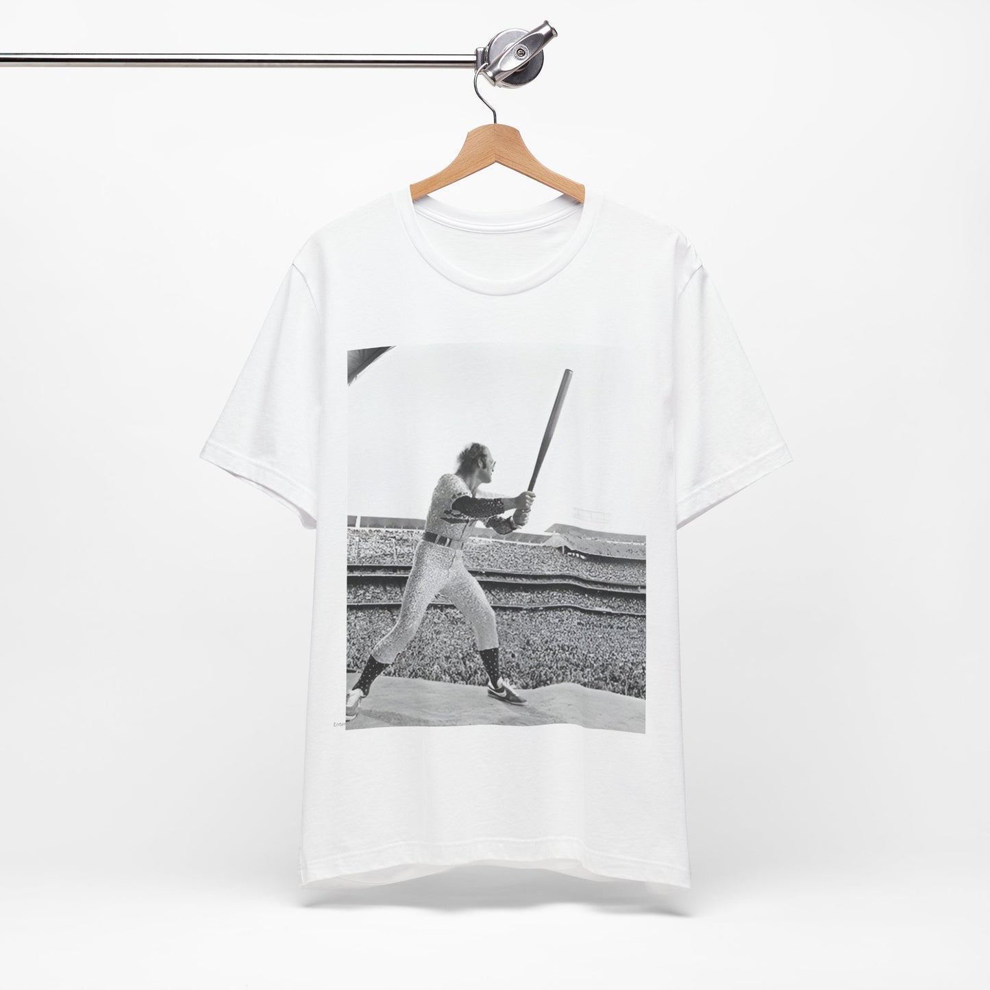A black graphic t-shirt featuring a black and white graphic or photo related to Elton John's 1975 tour in America.