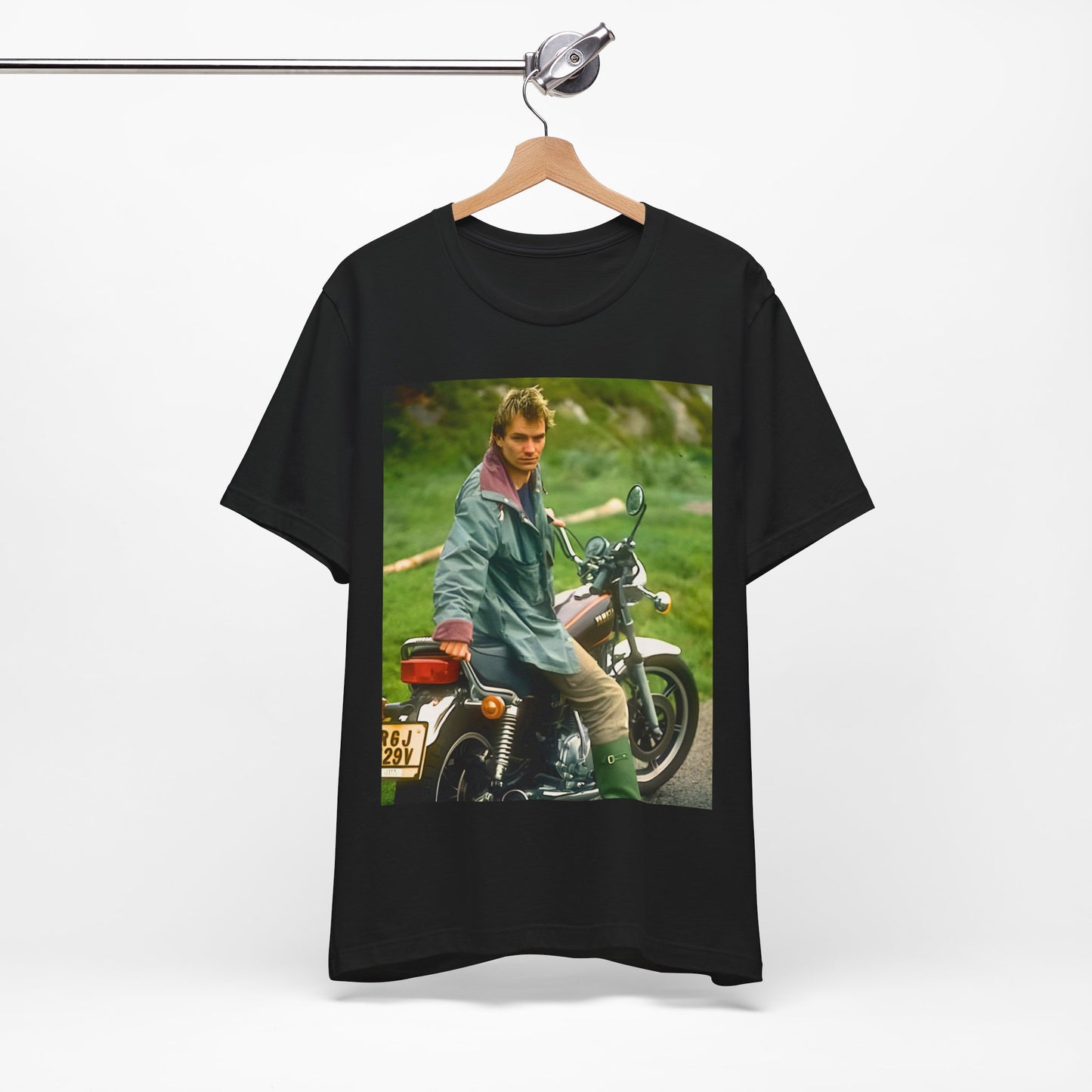A black graphic t-shirt featuring a graphic of Sting from The Police with a motorcycle theme.