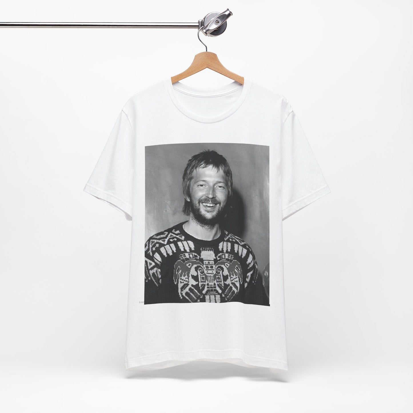 A black graphic t-shirt featuring a 70s photo portrait of Eric Clapton.