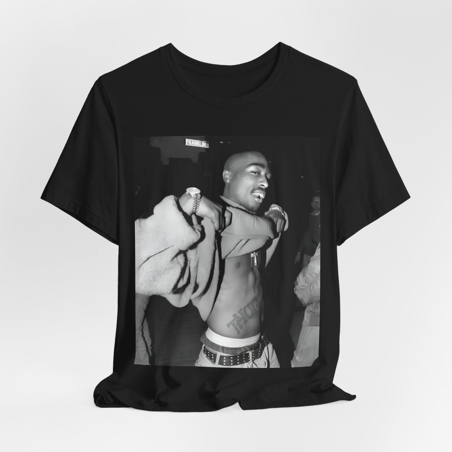A black graphic t-shirt featuring a vintage hip hop icon graphic of Tupac.