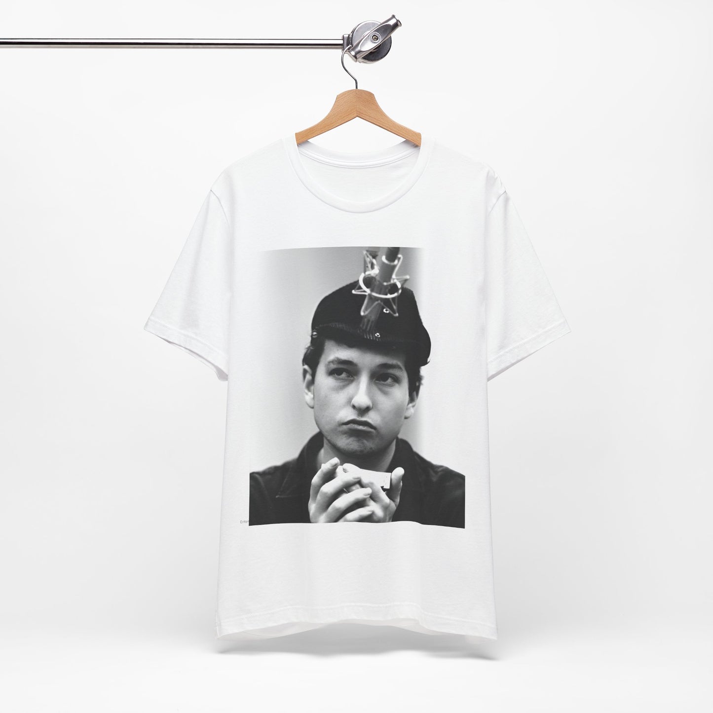 A black graphic t-shirt featuring a graphic of Bob Dylan in an acoustic session setting, possibly with his guitar.