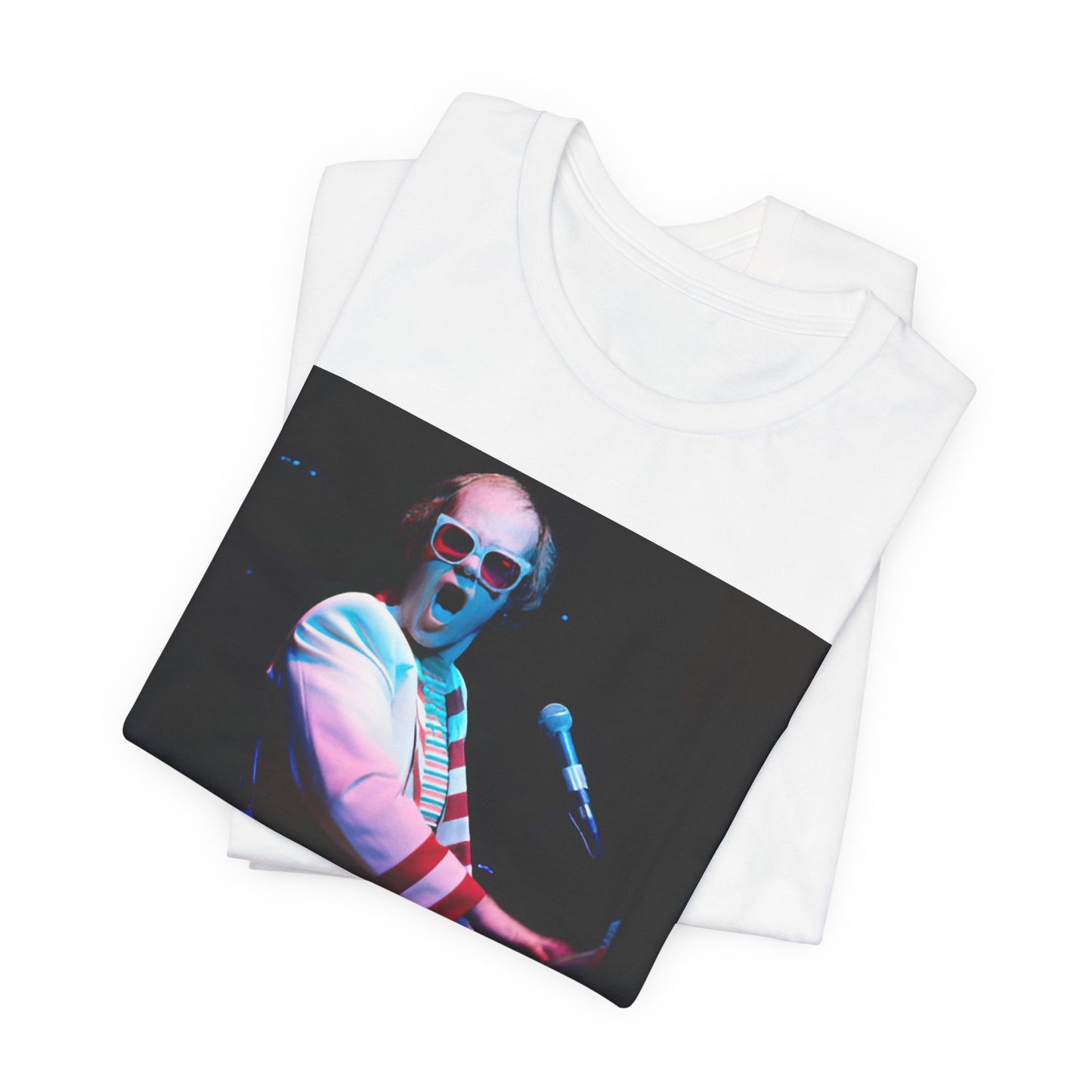 A black graphic t-shirt featuring a photo of Elton John performing live on stage at his piano.