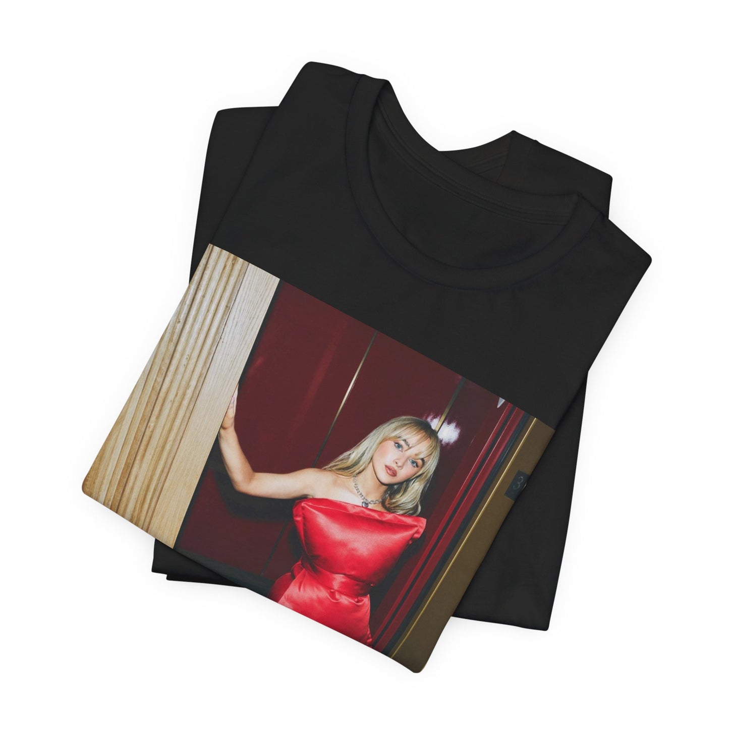 A black graphic t-shirt featuring a graphic of Sabrina Carpenter with 'hot pop vibes'.