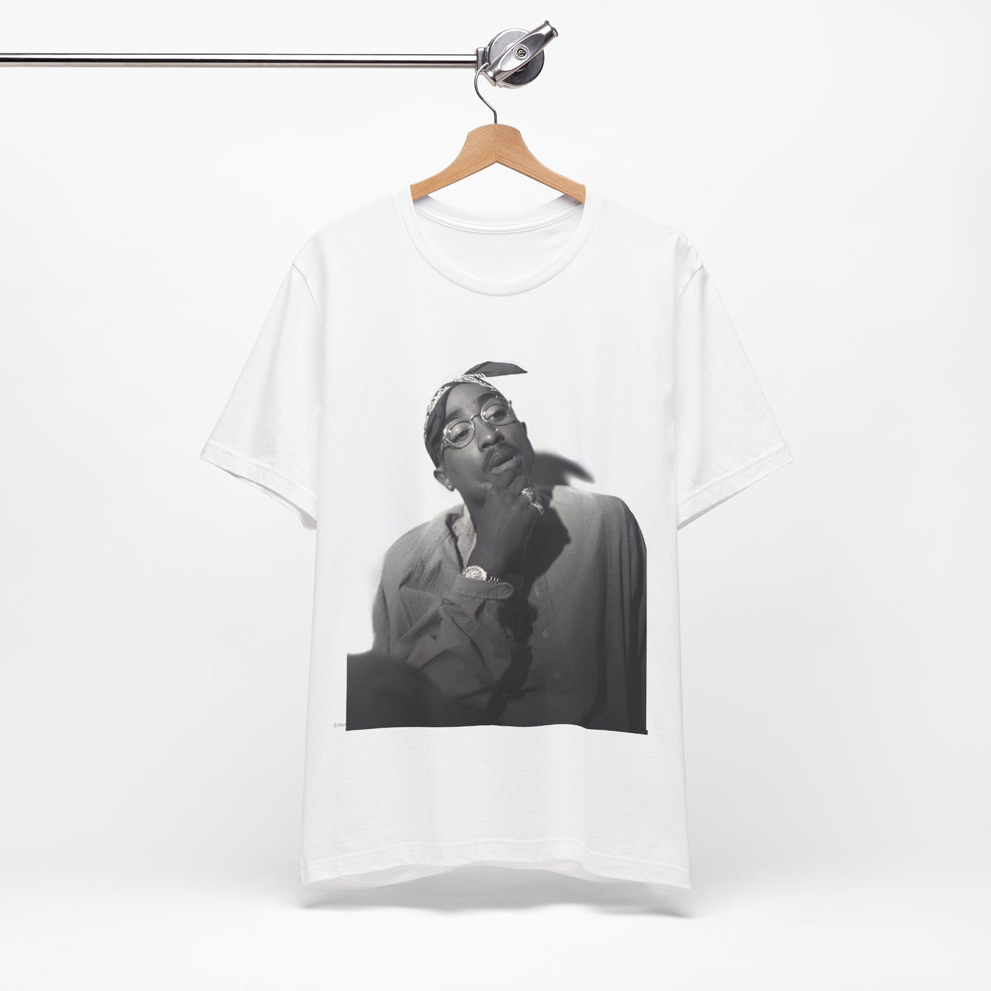 A black graphic t-shirt featuring a classic 90s West Coast rap graphic of Tupac.