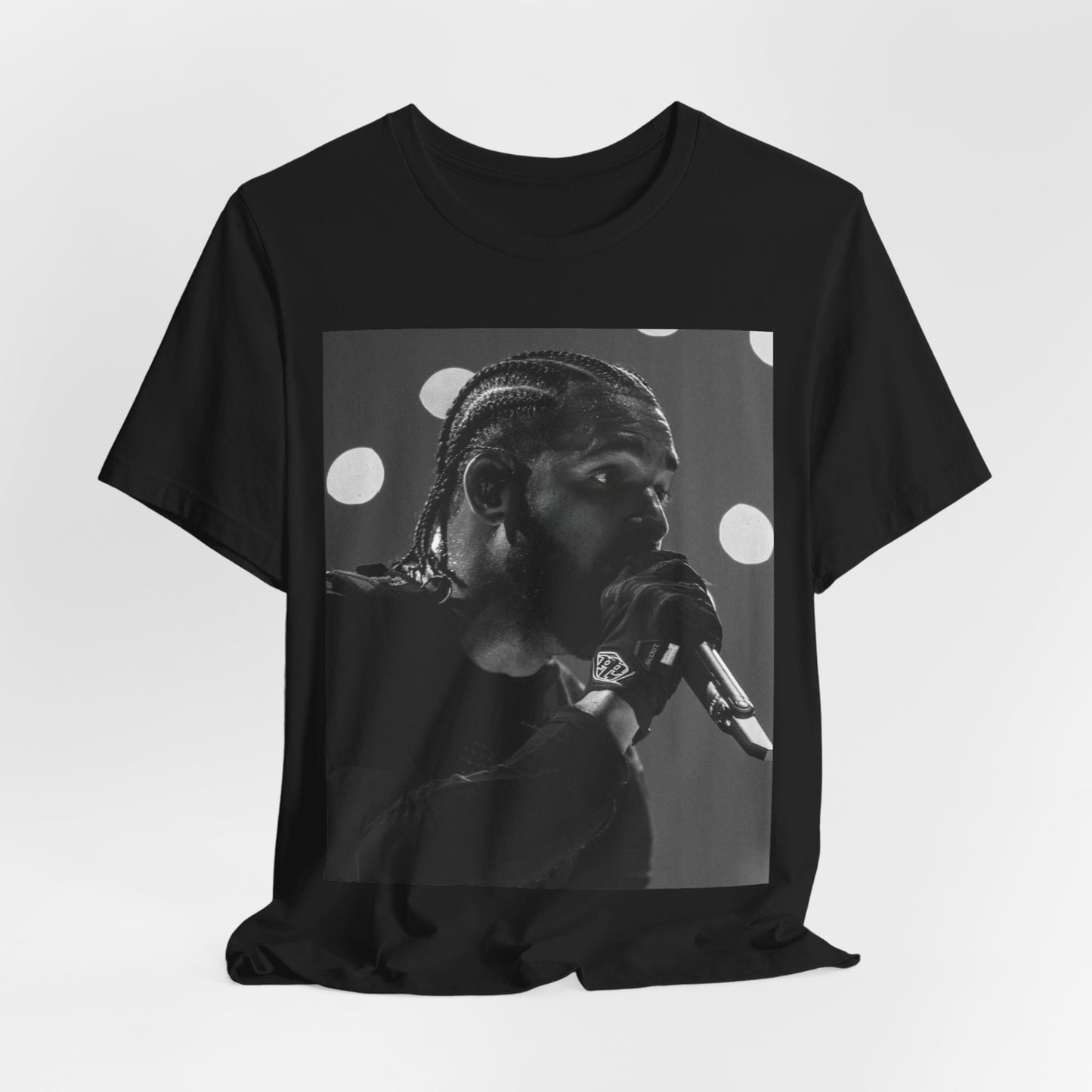 A black graphic t-shirt featuring a classic black and white style graphic of Drake.