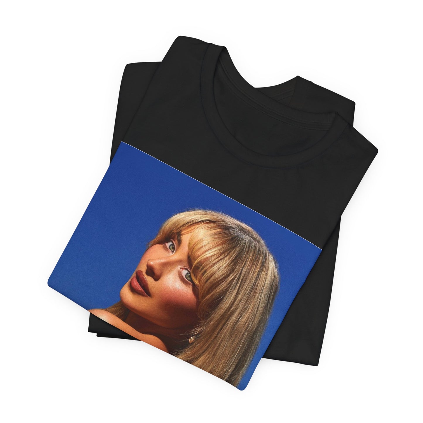 A black graphic t-shirt featuring a stylized graphic of Sabrina Carpenter, designed with a modern pop aesthetic.