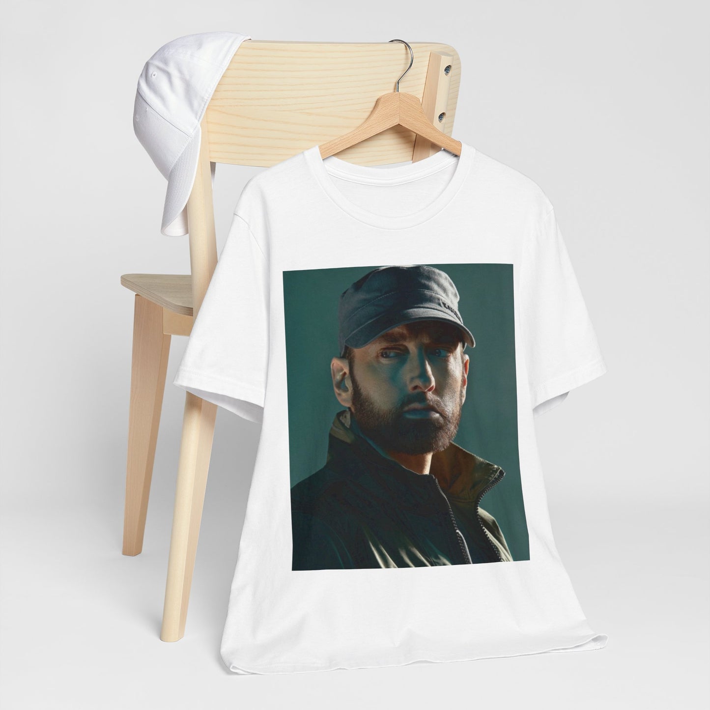 A black graphic t-shirt featuring a graphic of Eminem as a rap genius.