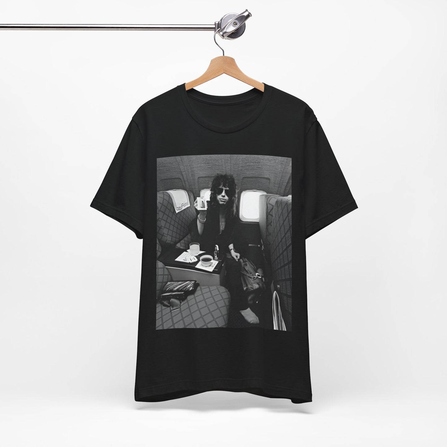 A black graphic t-shirt featuring a vintage 70s-style illustration of an airplane with Aerosmith branding, representing their tour plane from that era.