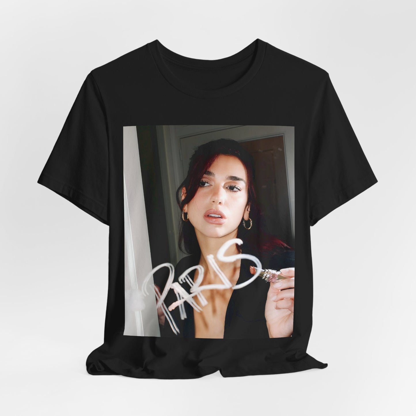 A black graphic t-shirt featuring a graphic of Dua Lipa, possibly with Parisian elements or a 'Paris' theme.
