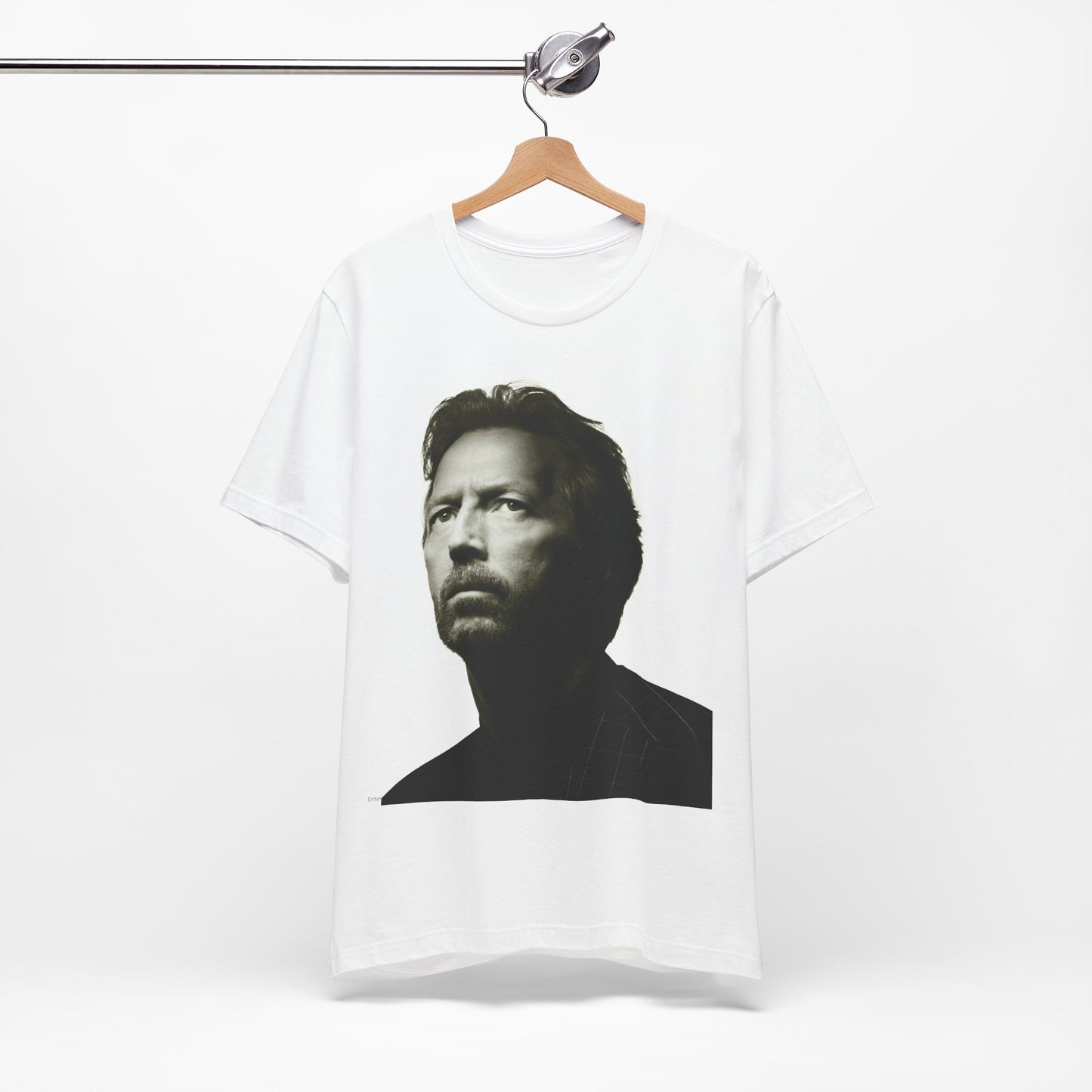 A black graphic t-shirt featuring a retro black and white portrait photo of Eric Clapton.