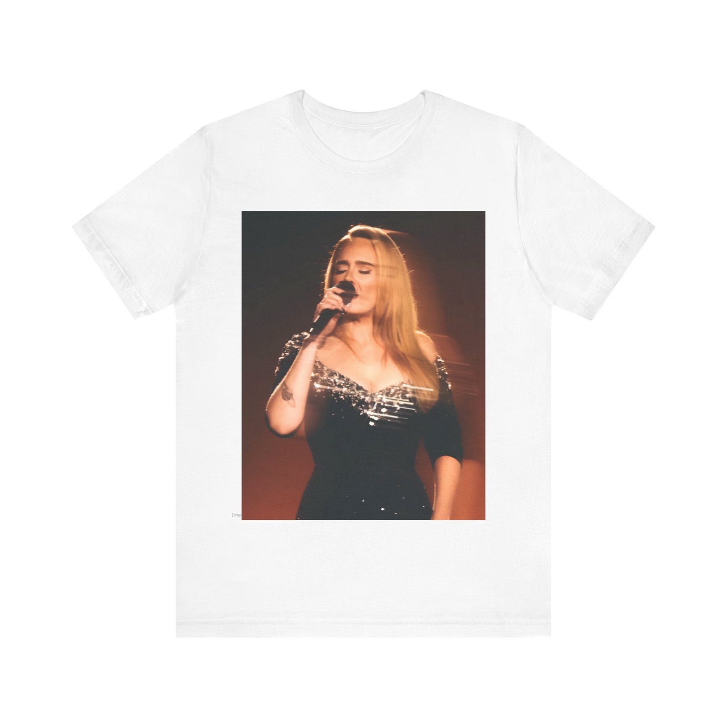 A black graphic t-shirt featuring a stylized image or photo of Adele related to her Las Vegas residency, possibly with elements of stage lighting or show branding.