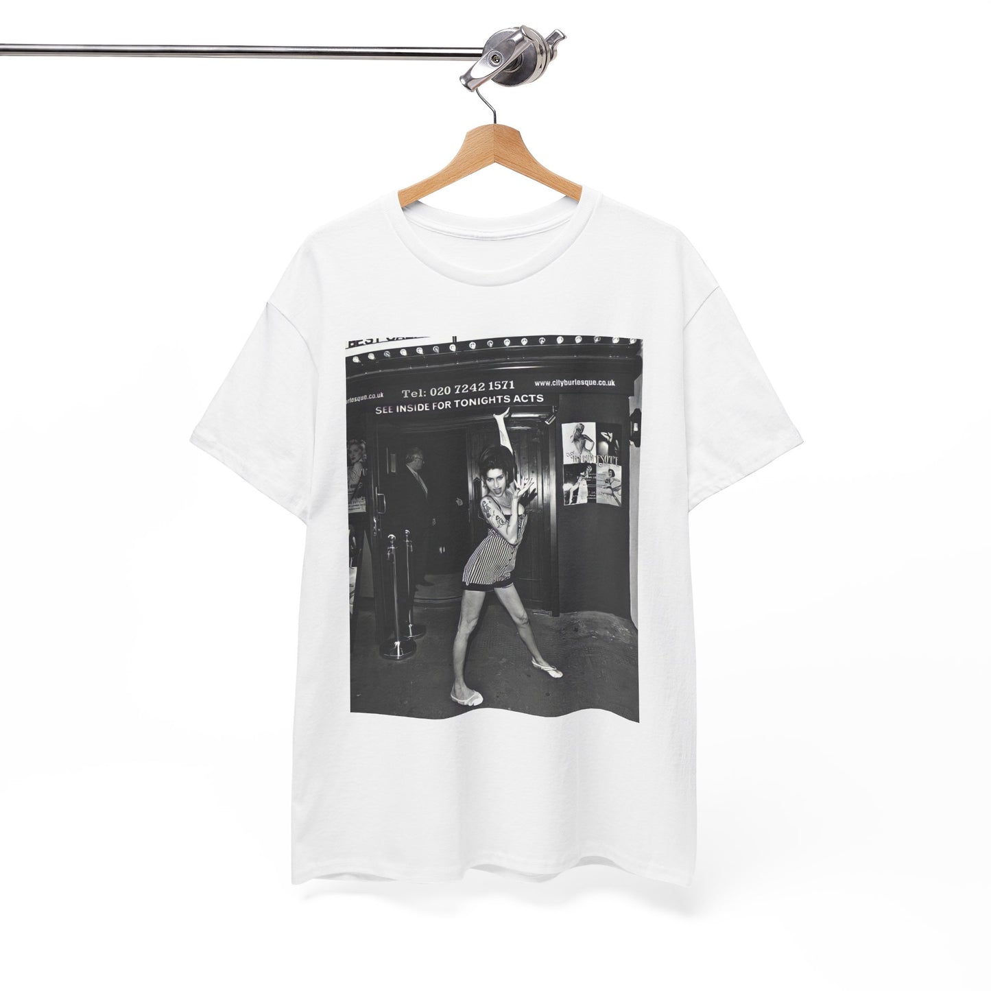 A black graphic t-shirt featuring a black and white graphic of Amy Winehouse in a burlesque club setting, stylized to evoke that ambiance.