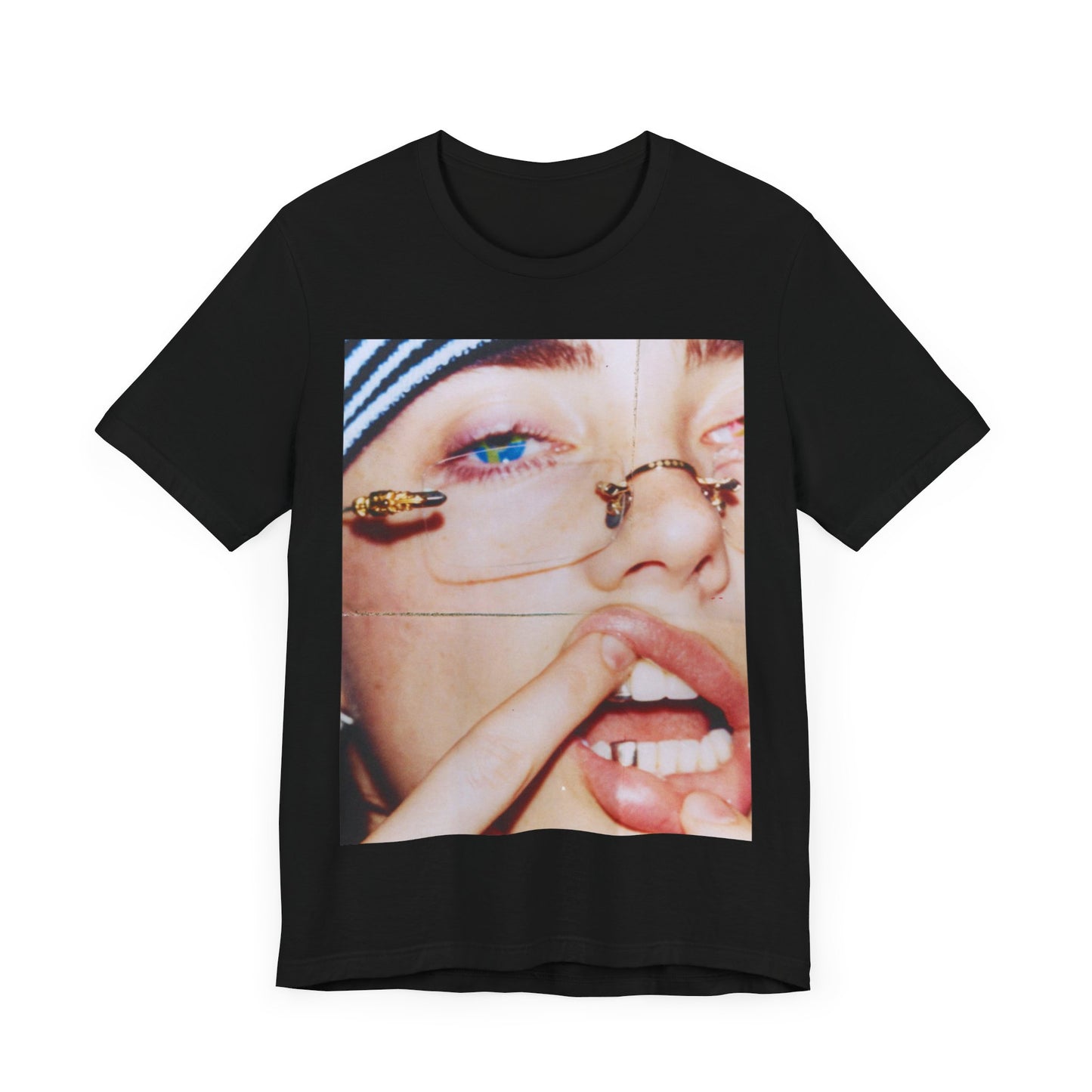 A direct, unfiltered, close-up portrait of Billie Eilish with dark hair looking straight at the camera, printed on a t-shirt.