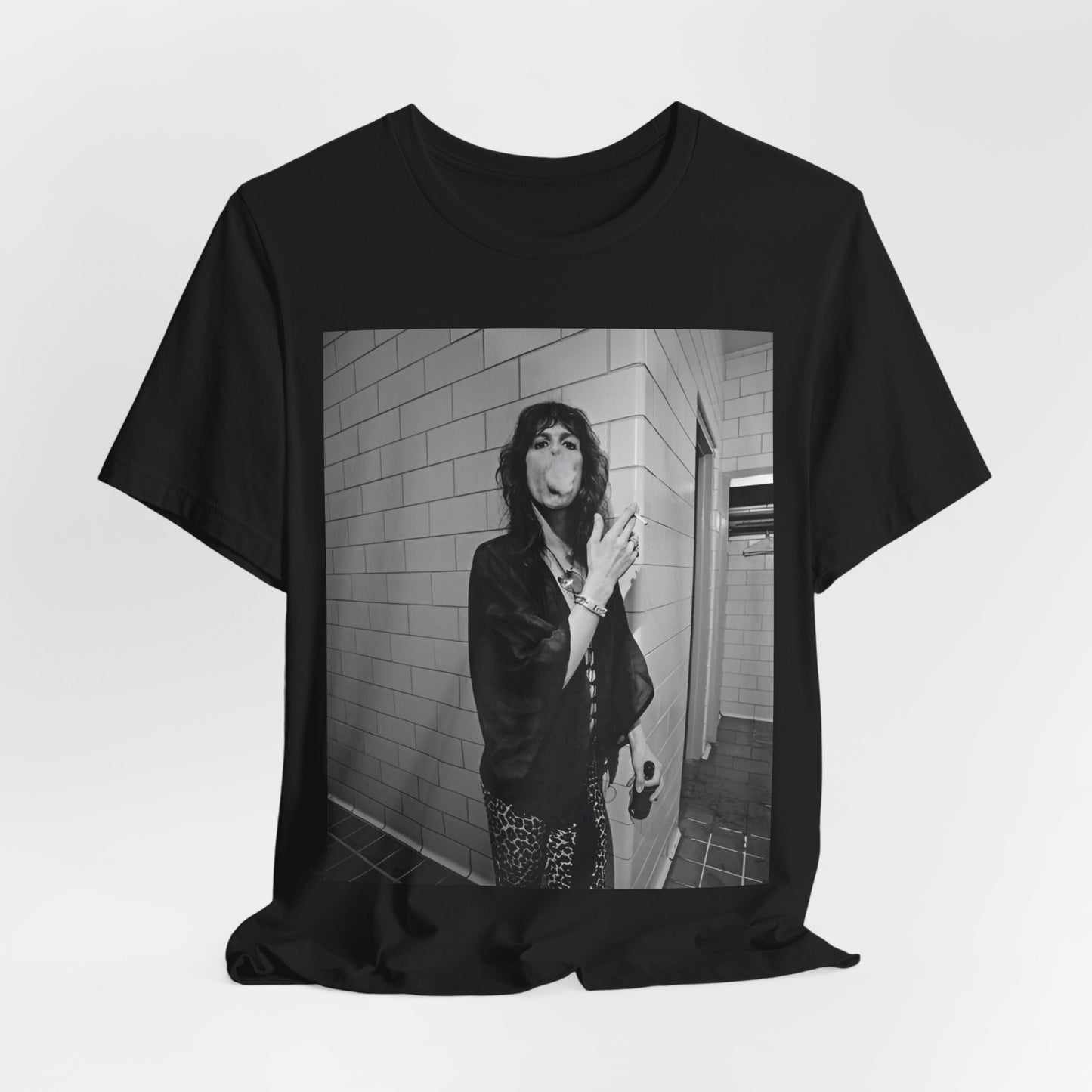 A black graphic t-shirt featuring a retro 70s photo of Aerosmith band members in a backstage setting, showing a candid moment.