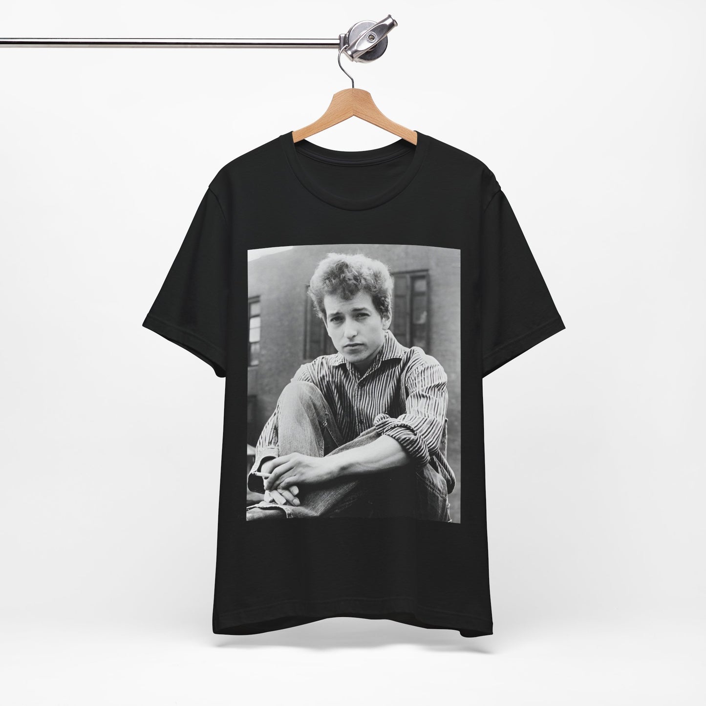 A black graphic t-shirt featuring a graphic of Bob Dylan from his 60s origins in folk music.