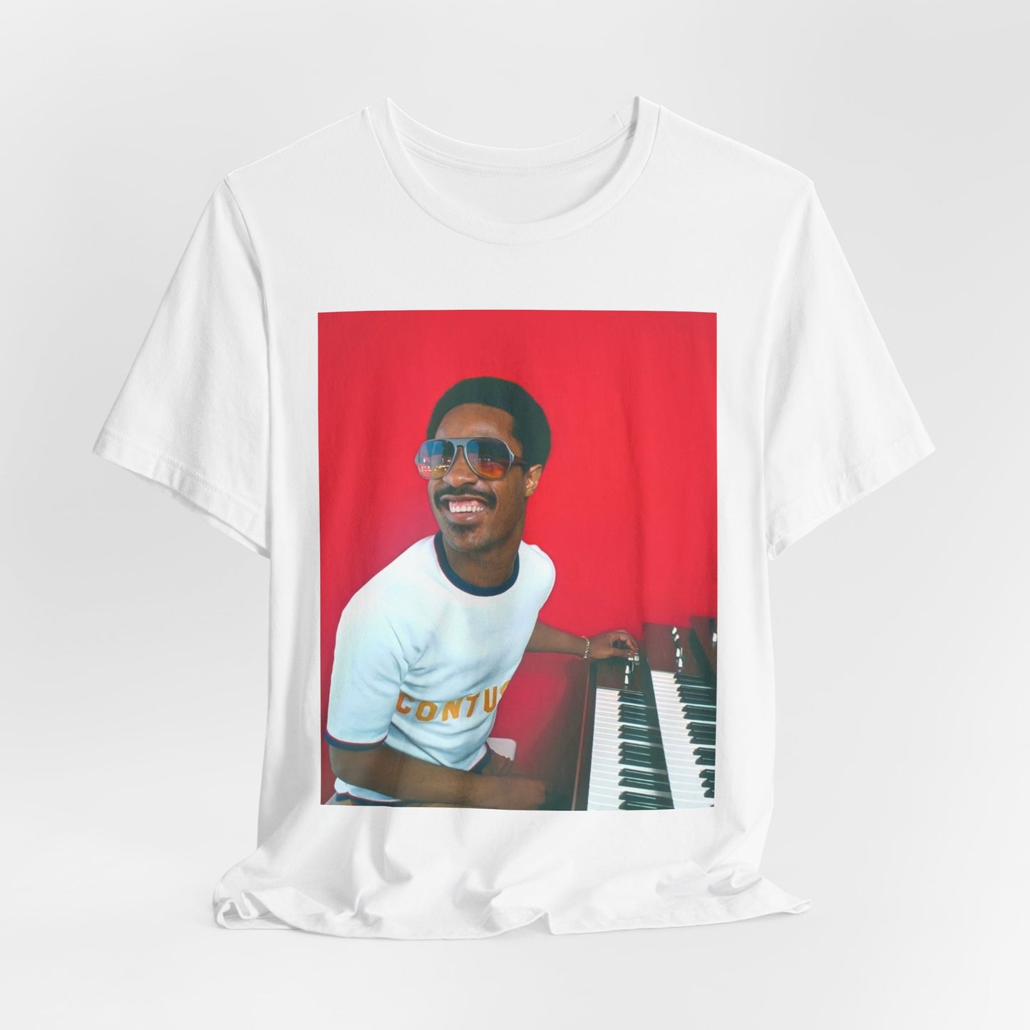 A black graphic t-shirt featuring a graphic of Stevie Wonder with a piano.
