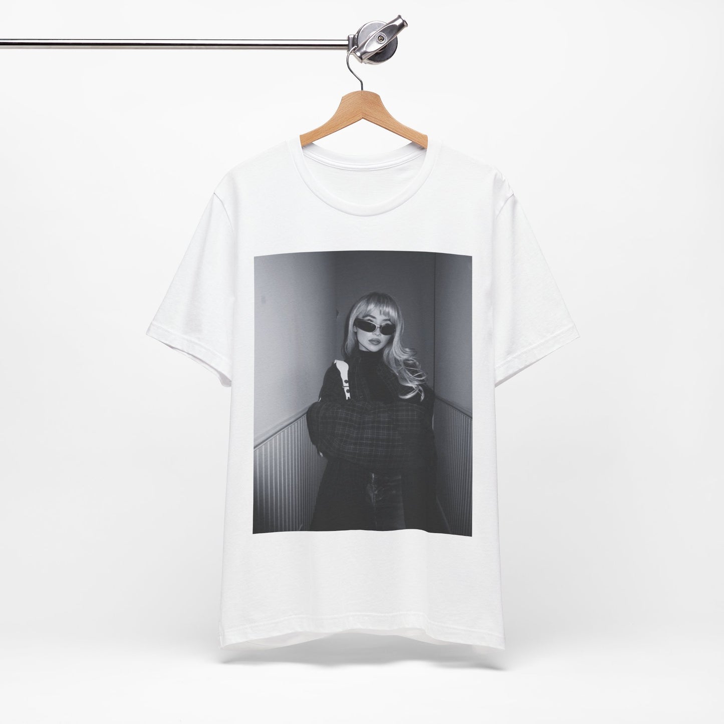 A black graphic t-shirt featuring a black and white glam pop diva graphic of Sabrina Carpenter.
