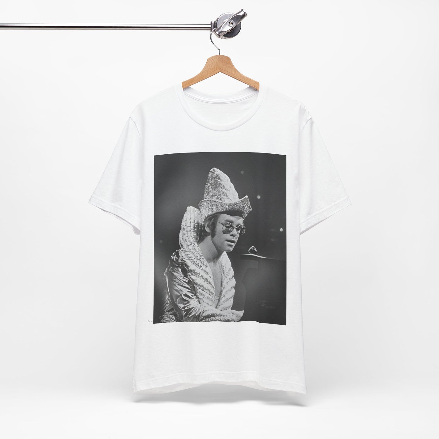 A black graphic t-shirt featuring a 70s pop aesthetic graphic of Elton John.