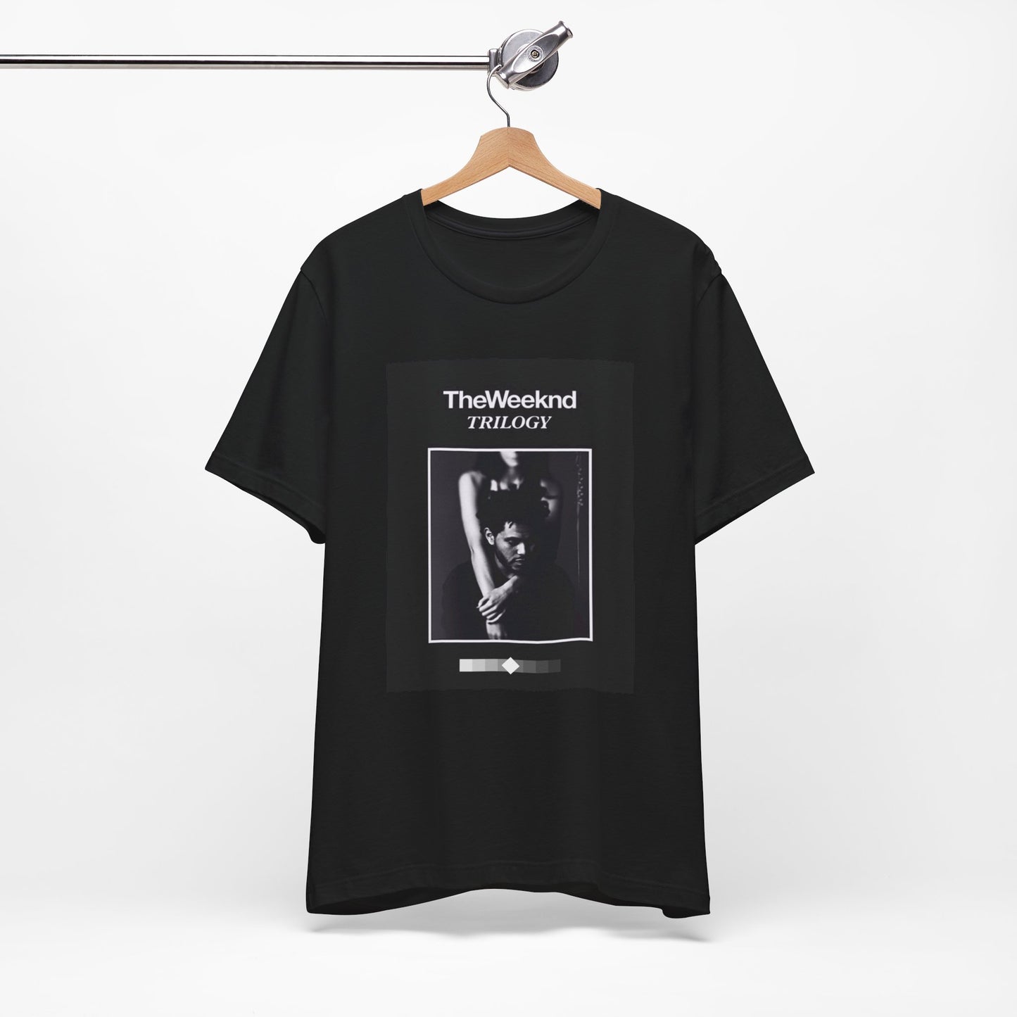 A black graphic t-shirt featuring a graphic related to The Weeknd's 'Trilogy' album.